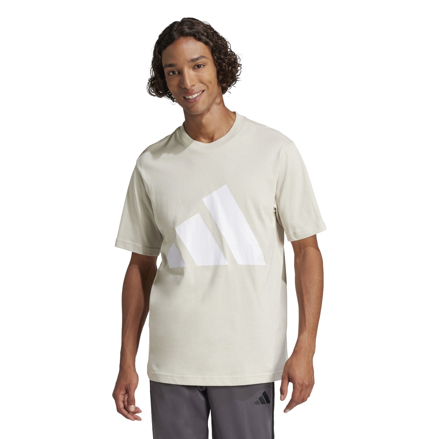 Adidas mens t-shirt with logo displayed outdoors.