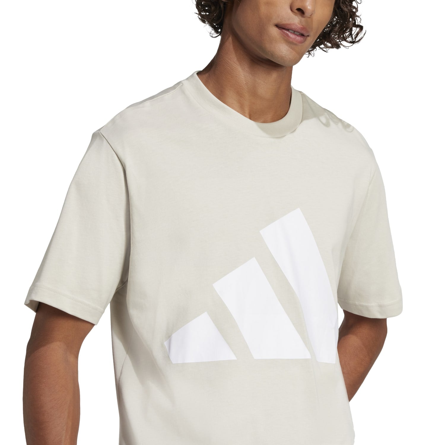 Front view of Adidas mens iconic tee in a gym setting.