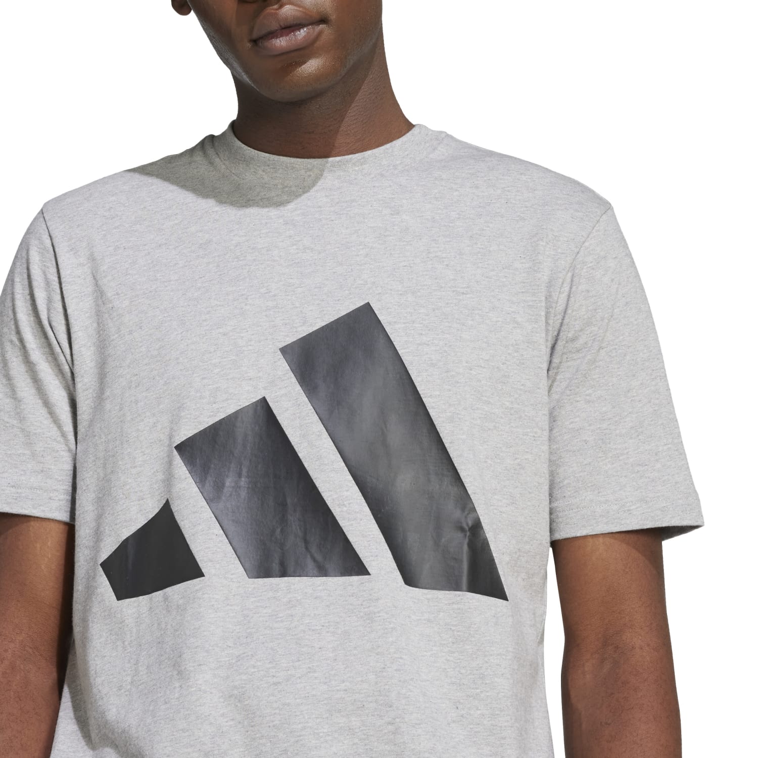 Lifestyle shot of model pairing the sports t-shirt with jeans outdoors