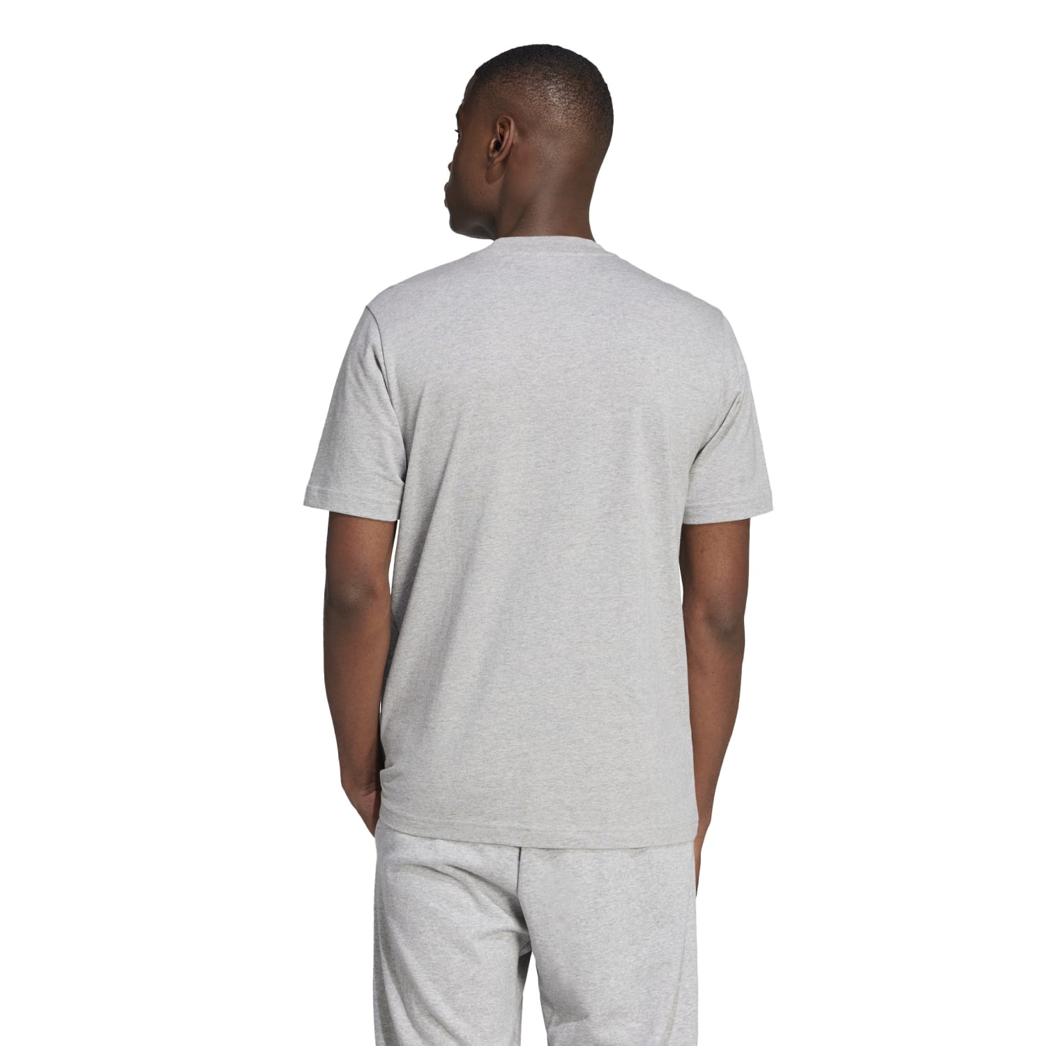 Lifestyle shot of model pairing the sports t-shirt with jeans outdoors