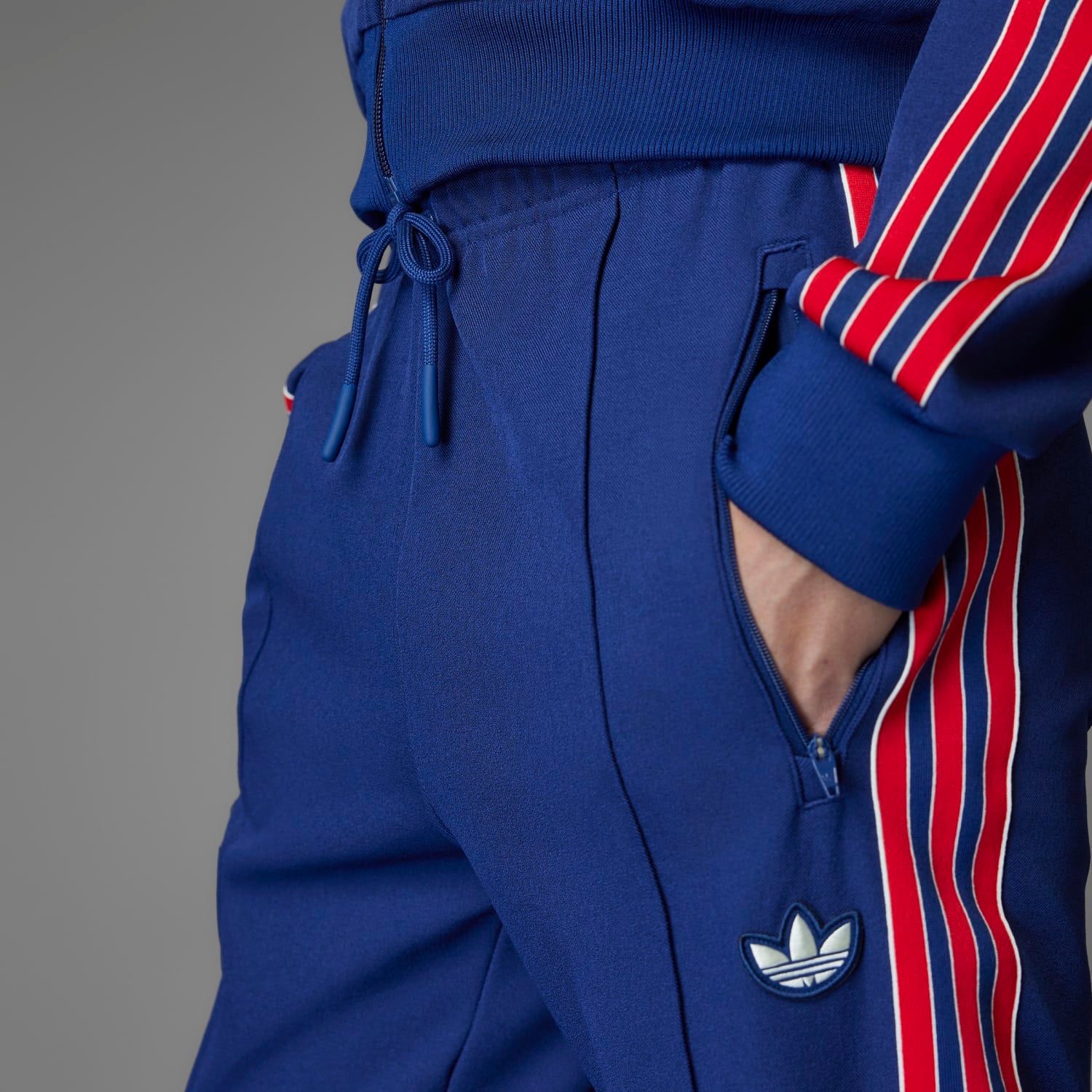 Side view of adidas Arsenal Icon Mens Track Pants with ribbed cuffs, perfect for casual outings.