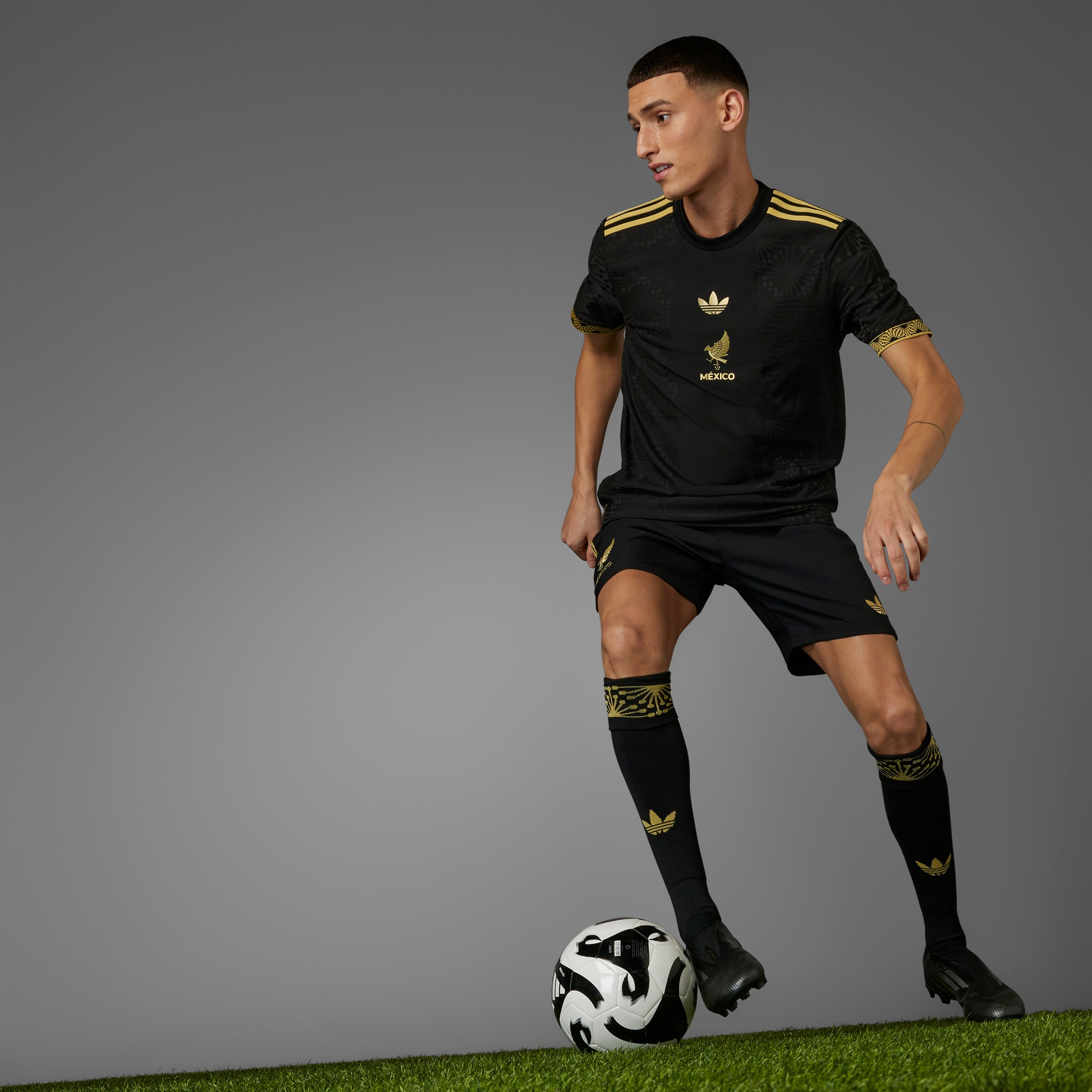 Close-up of the heat-applied Mexico crest on the Adidas Gold jersey, showcasing quality and detail.