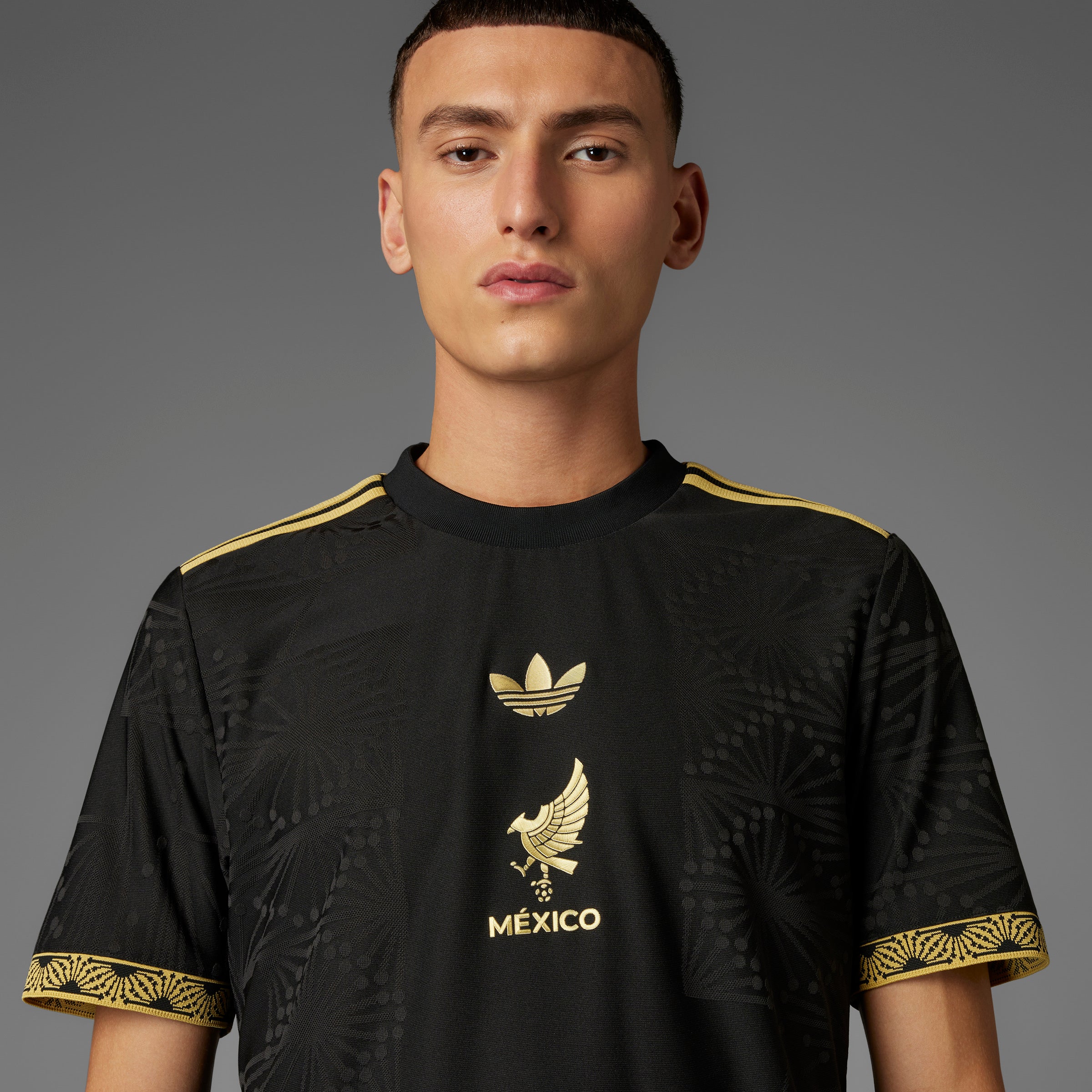 Front view of the Adidas Mexico Gold jersey for men, highlighting the gold details and team crest.