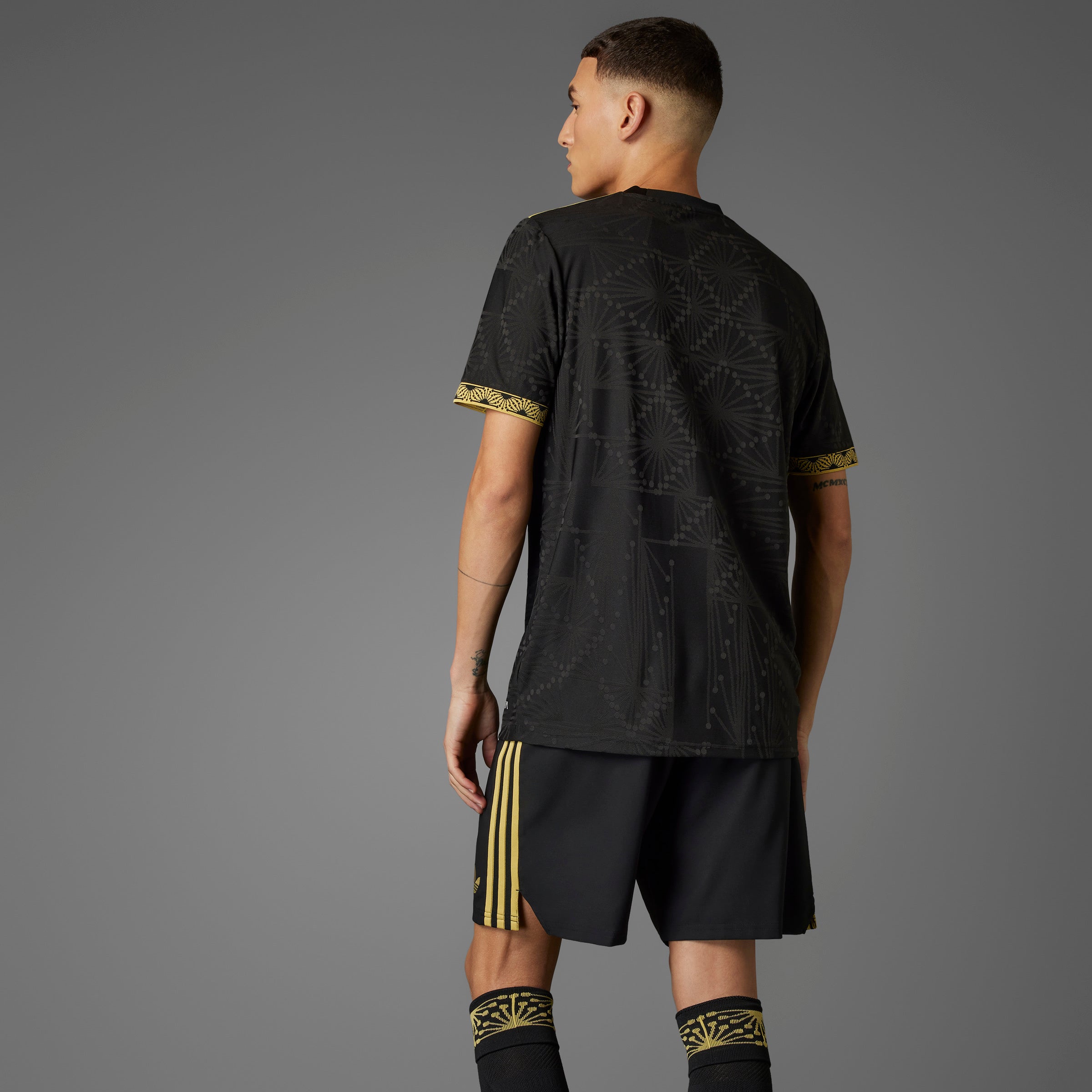 Side angle of the Mexico national team gold jersey, demonstrating the slim fit and crewneck design.