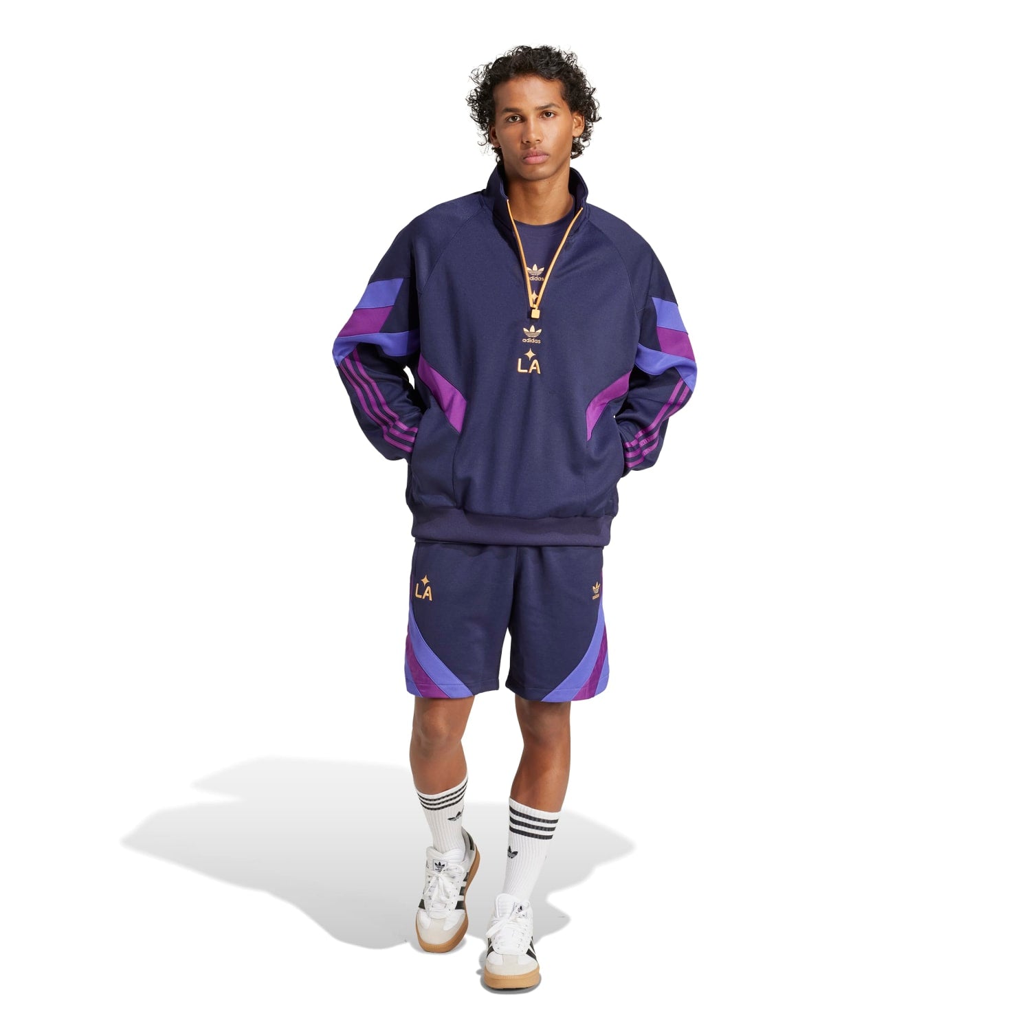 Model wearing mens track top in casual outdoor setting