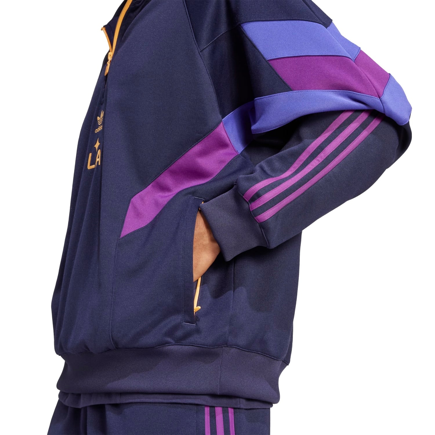 Model wearing mens track top in casual outdoor setting