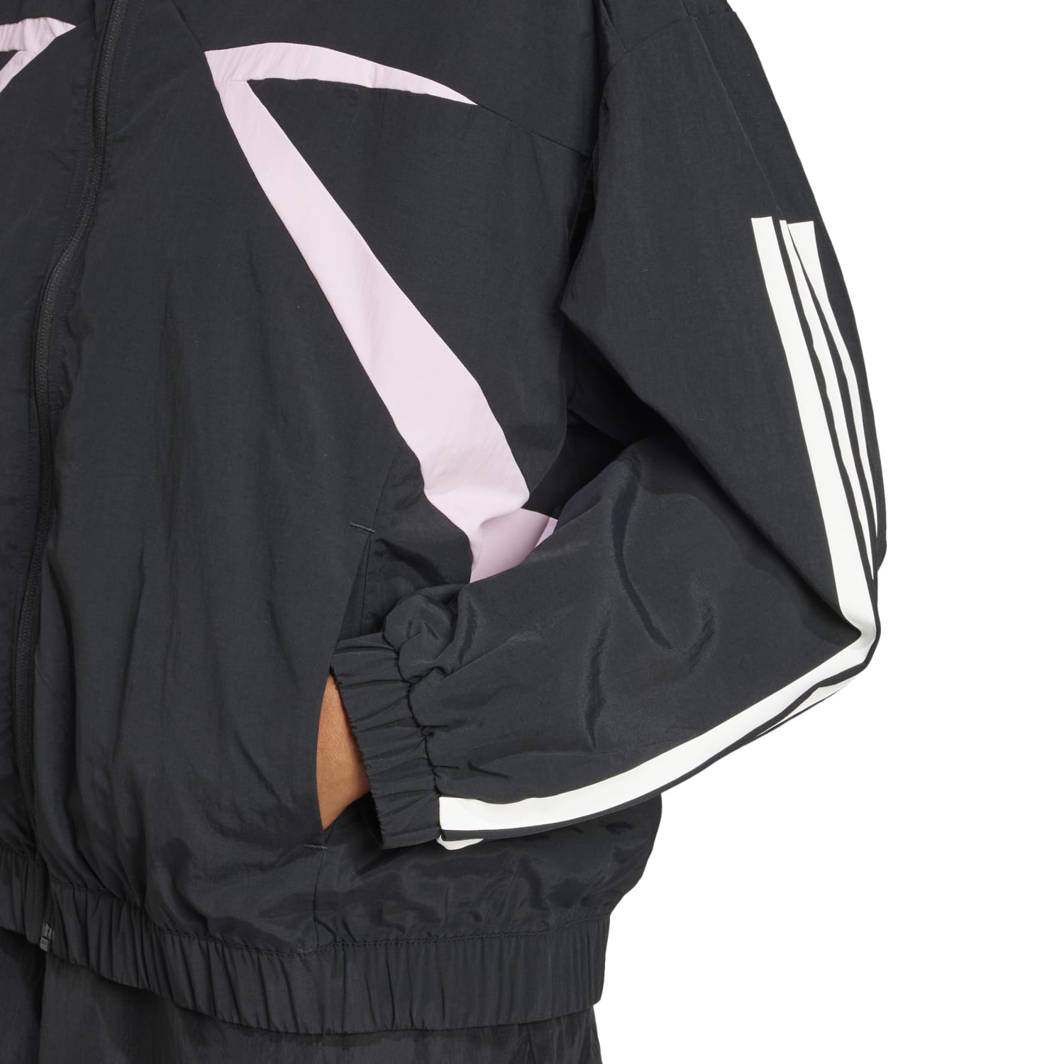 Close-up of the side pockets and silicone badge on the womens sports jacket