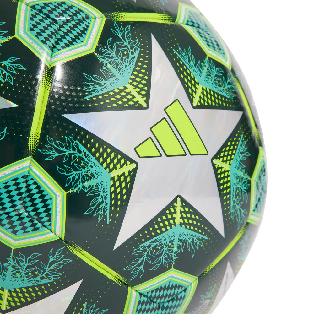 Side angle of the cheap champions league foil soccer ball beside a pair of cleats, ready for practice