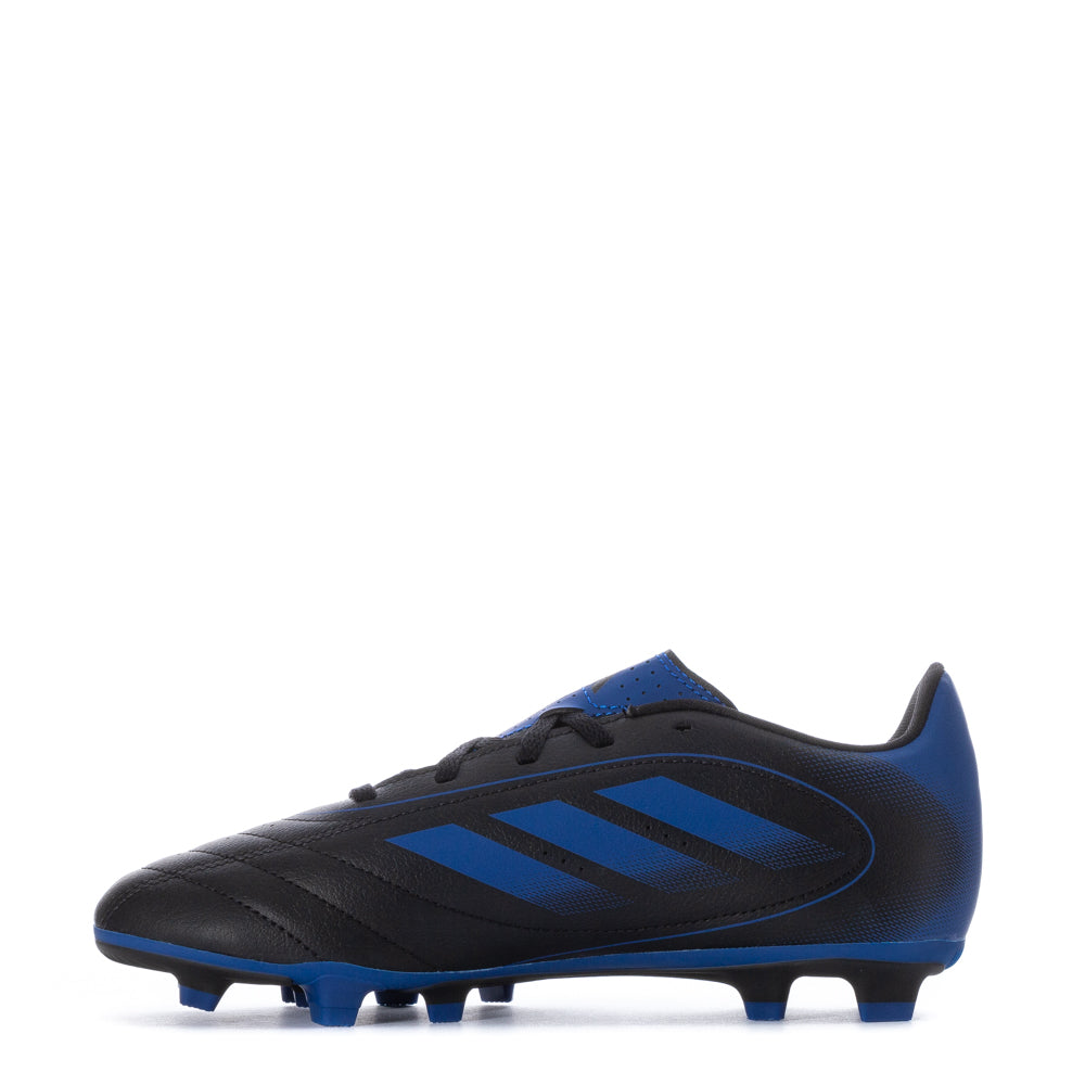 Action shot of kids wearing Adidas Goletto IX FG soccer cleats on artificial grass, demonstrating their versatility.