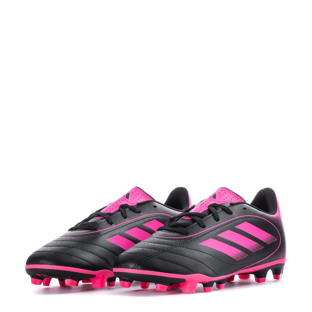 Youth athlete wearing Adidas Goletto IX soccer cleats on the field, demonstrating performance.