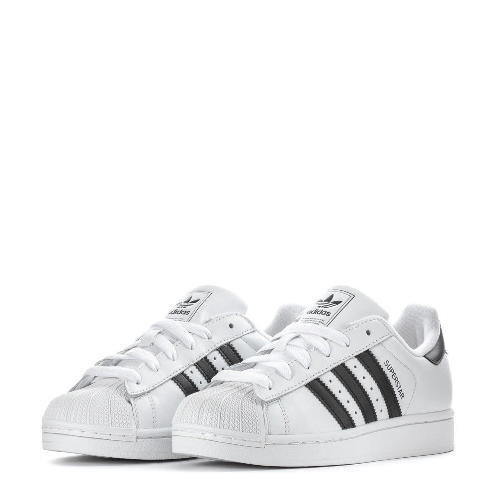 Adidas Superstar Womens Sneakers worn casually with denim, highlighting their versatility.