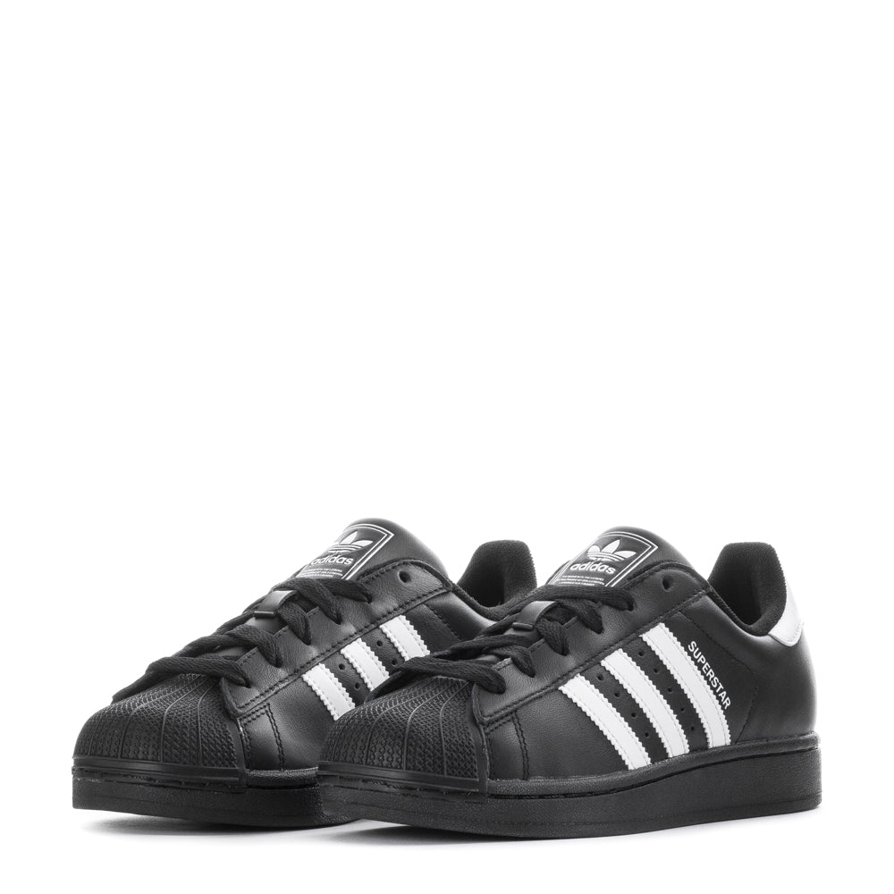 Adidas Superstar Womens Sneakers on a city street, demonstrating their stylish appeal and versatility.