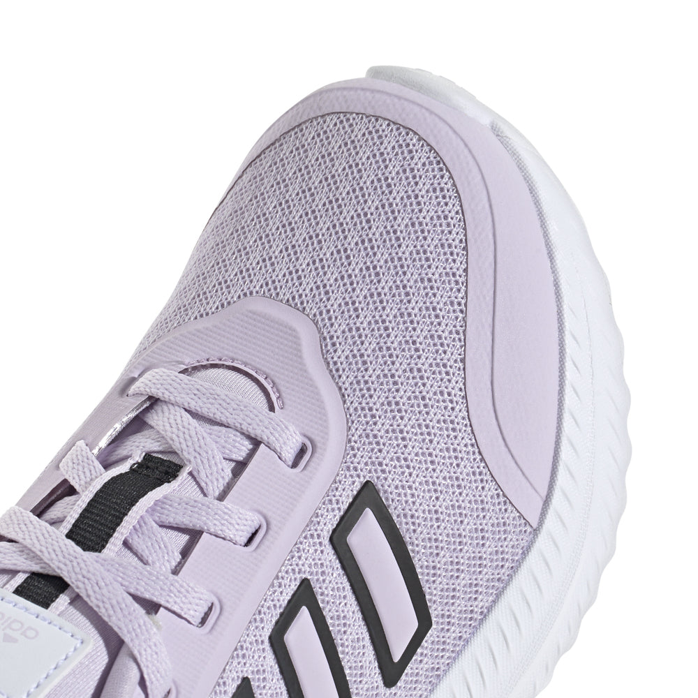 Kids running shoes in action on playground, highlighting rubber outsole grip