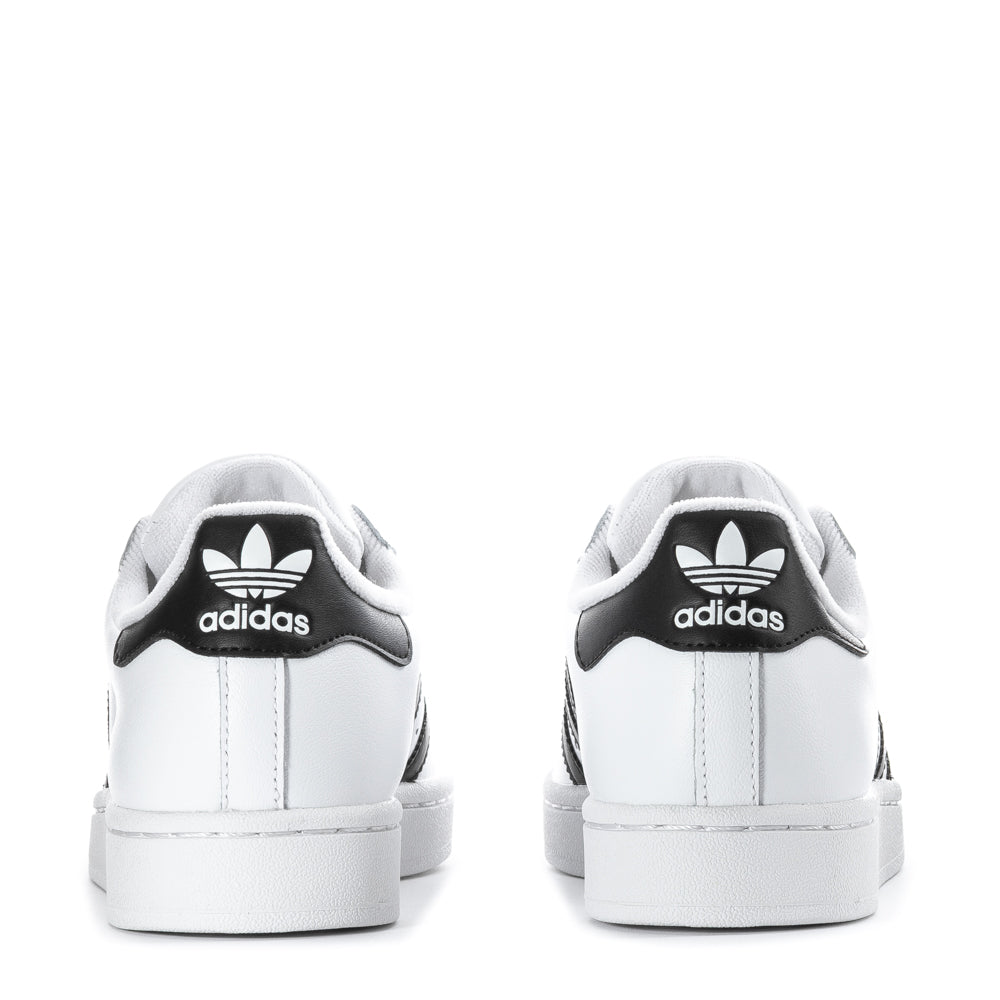 Side view of adidas youth shoes highlighting the signature 3-Stripes and cushioning