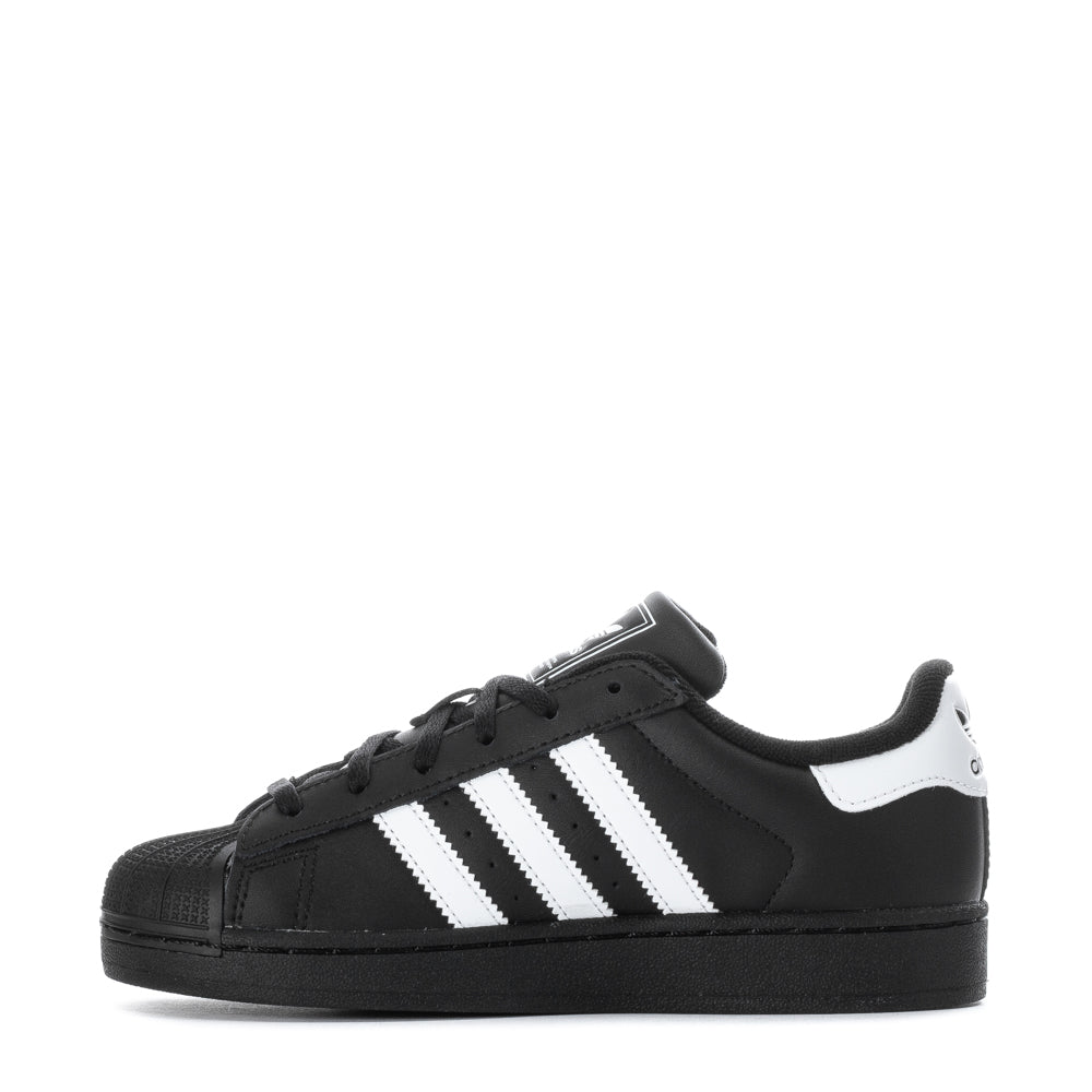 Child running outdoors in adidas Superstar II kids shoes, highlighting comfort and style