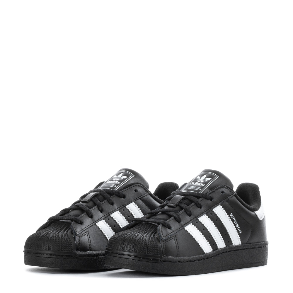 Side view of adidas Superstar II kids sneakers emphasizing the rubber outsole and padded collar