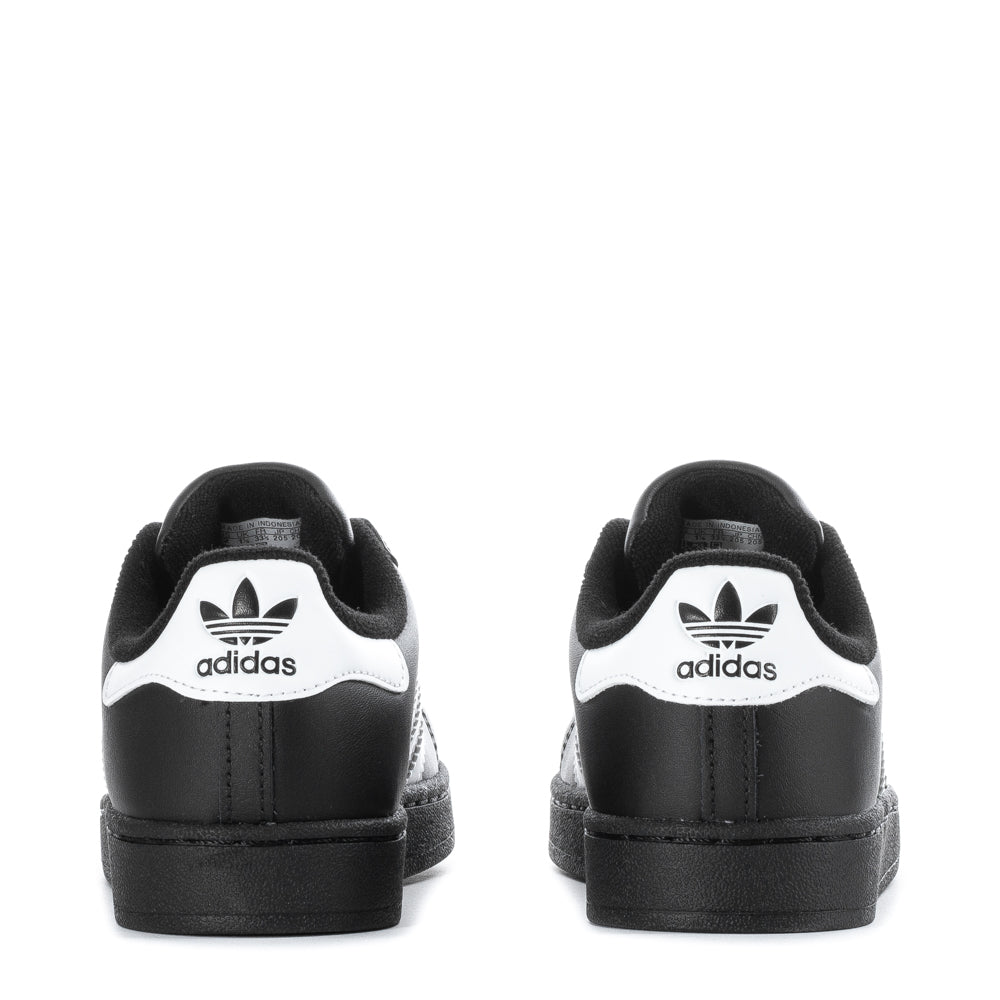 Child running outdoors in adidas Superstar II kids shoes, highlighting comfort and style