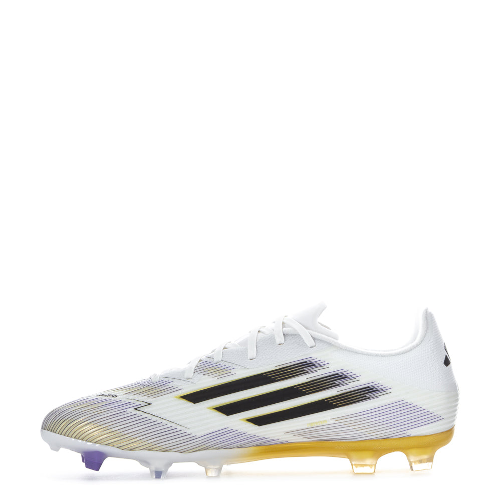 Side angle of player planting foot in F50 League FGxMG, highlighting multi-ground studs gripping firm natural grass
