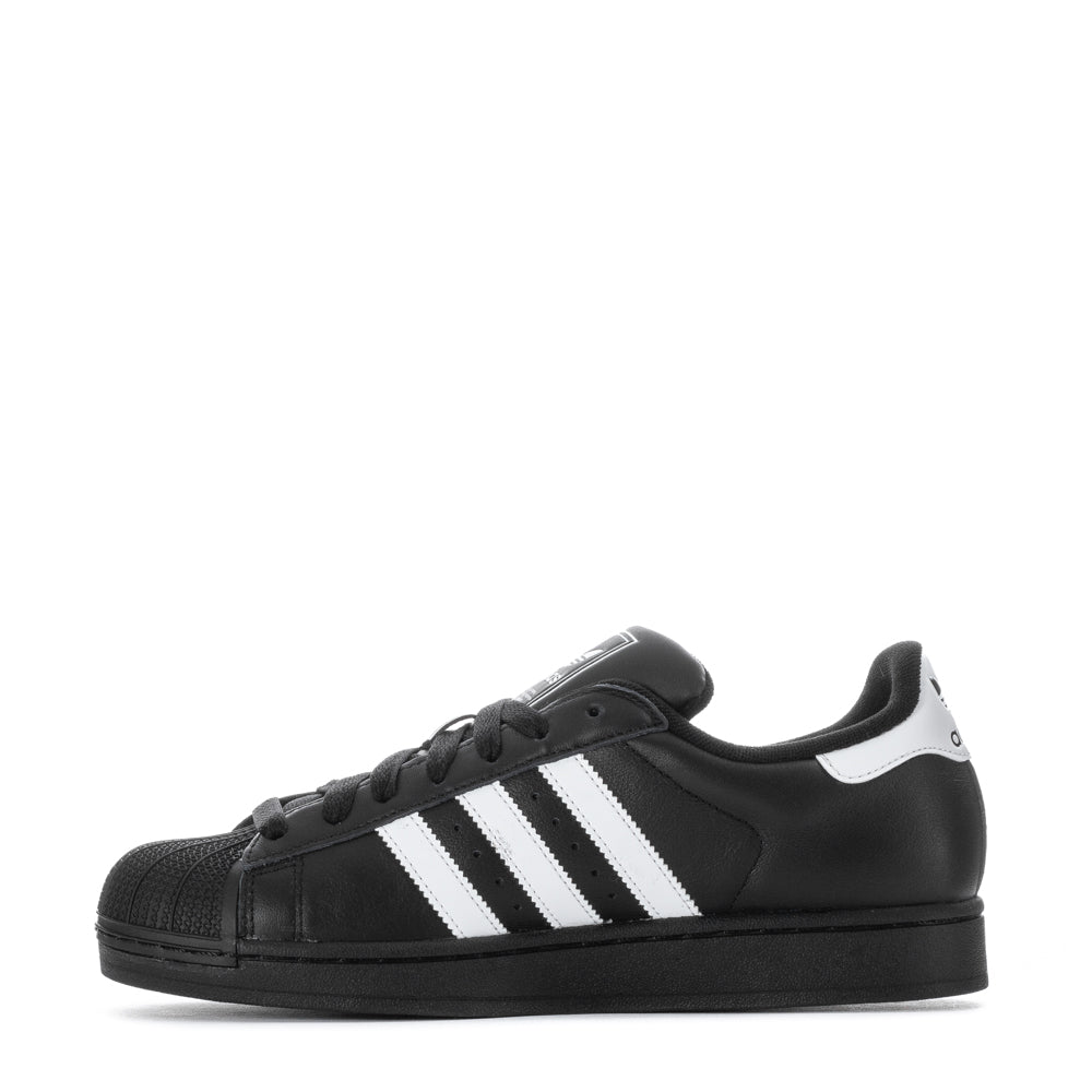 Side view of Adidas Superstar sneakers highlighting the signature 3-Stripes and padded collar