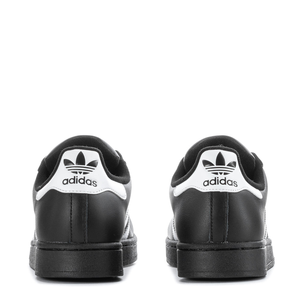 Side view of Adidas Superstar sneakers highlighting the signature 3-Stripes and padded collar