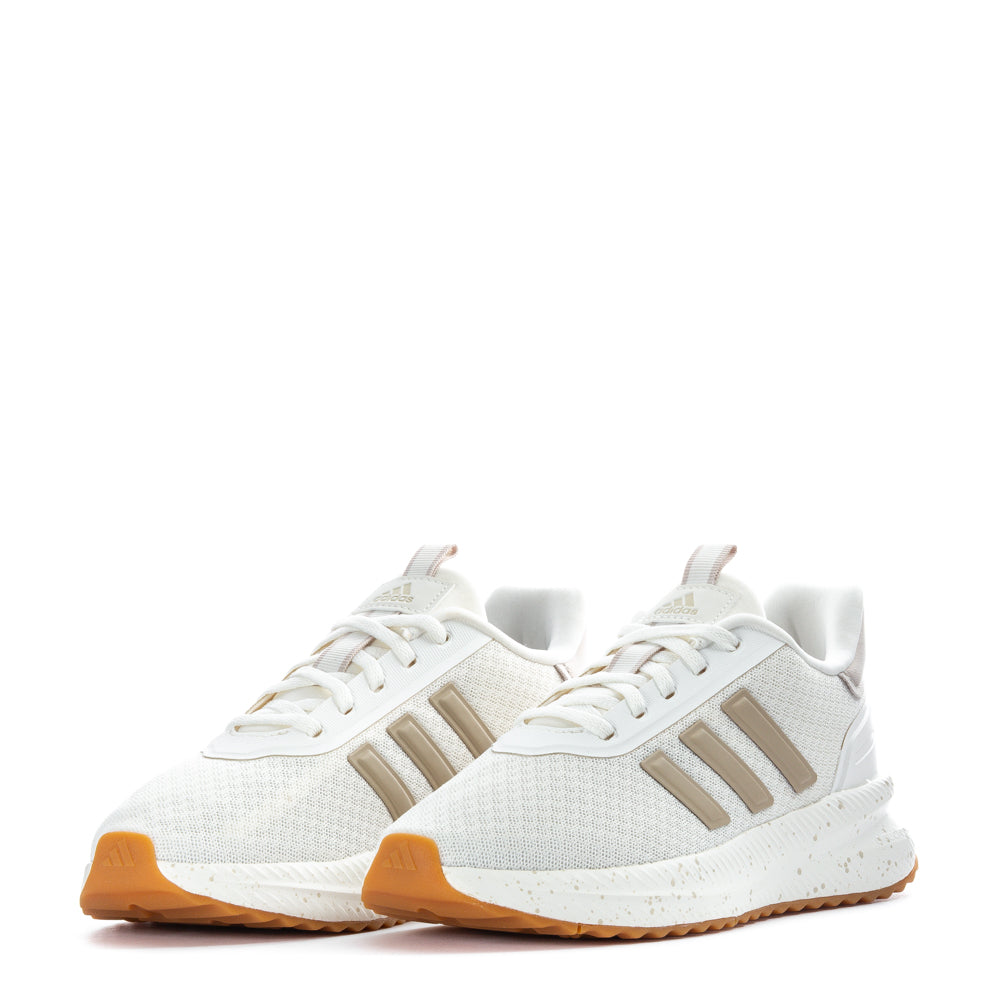 Model wearing Adidas X_PLR Path sneakers during a casual walk outdoors