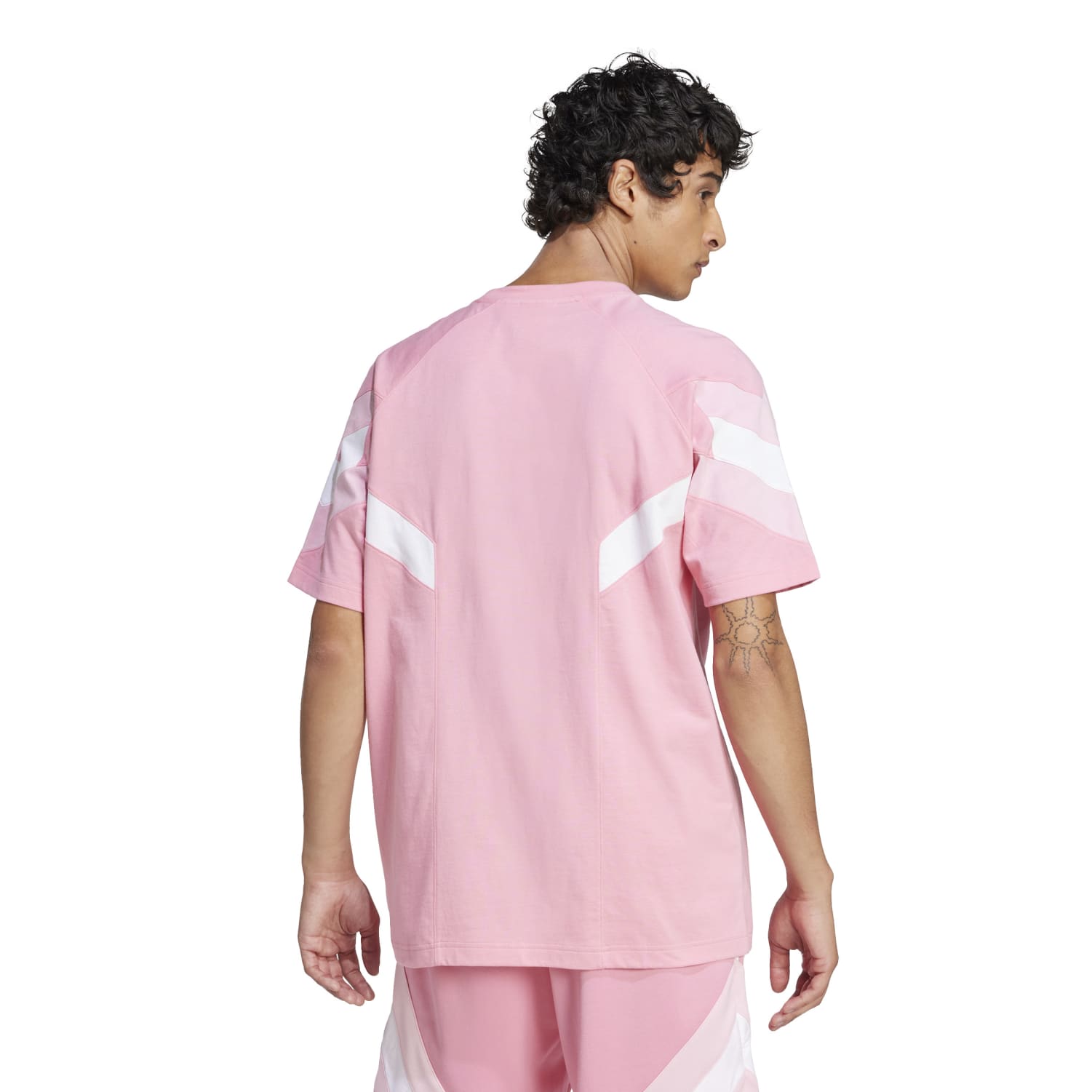 Model wearing Inter Miami football jersey while playing soccer.