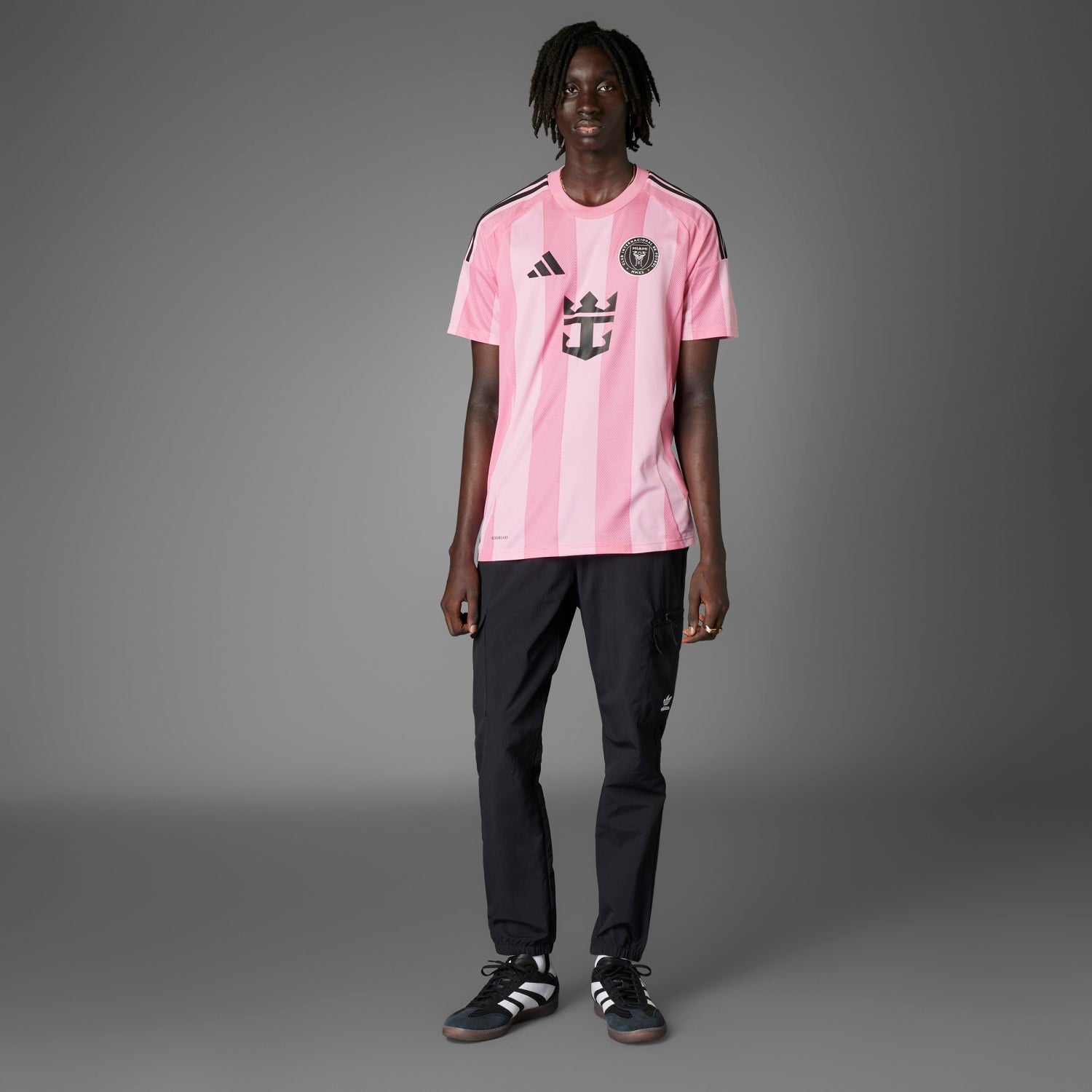 Model wearing the Inter Miami replica jersey at a soccer stadium