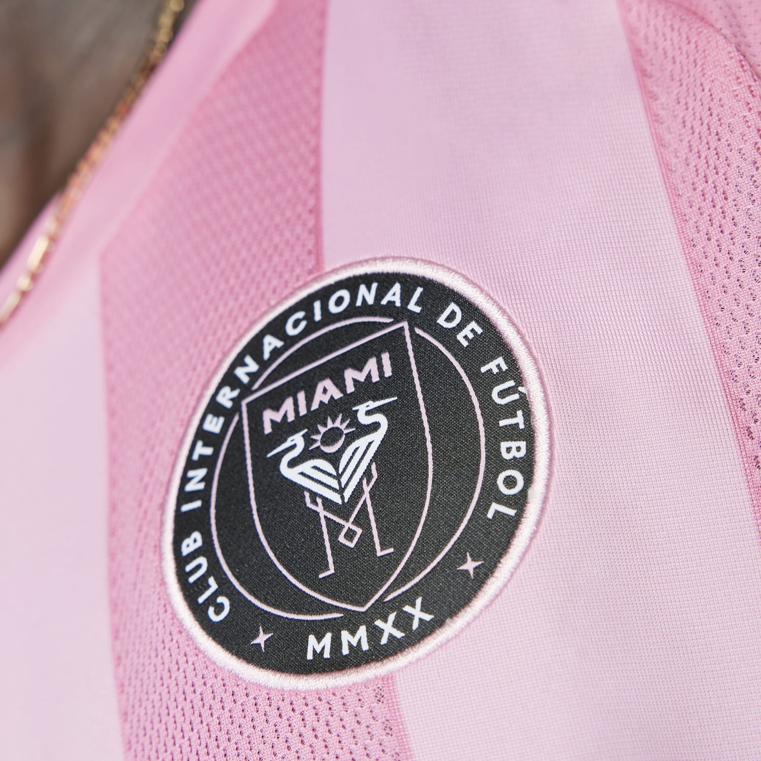 Close-up of the adidas signature three stripes on the sleeve of the soccer jersey