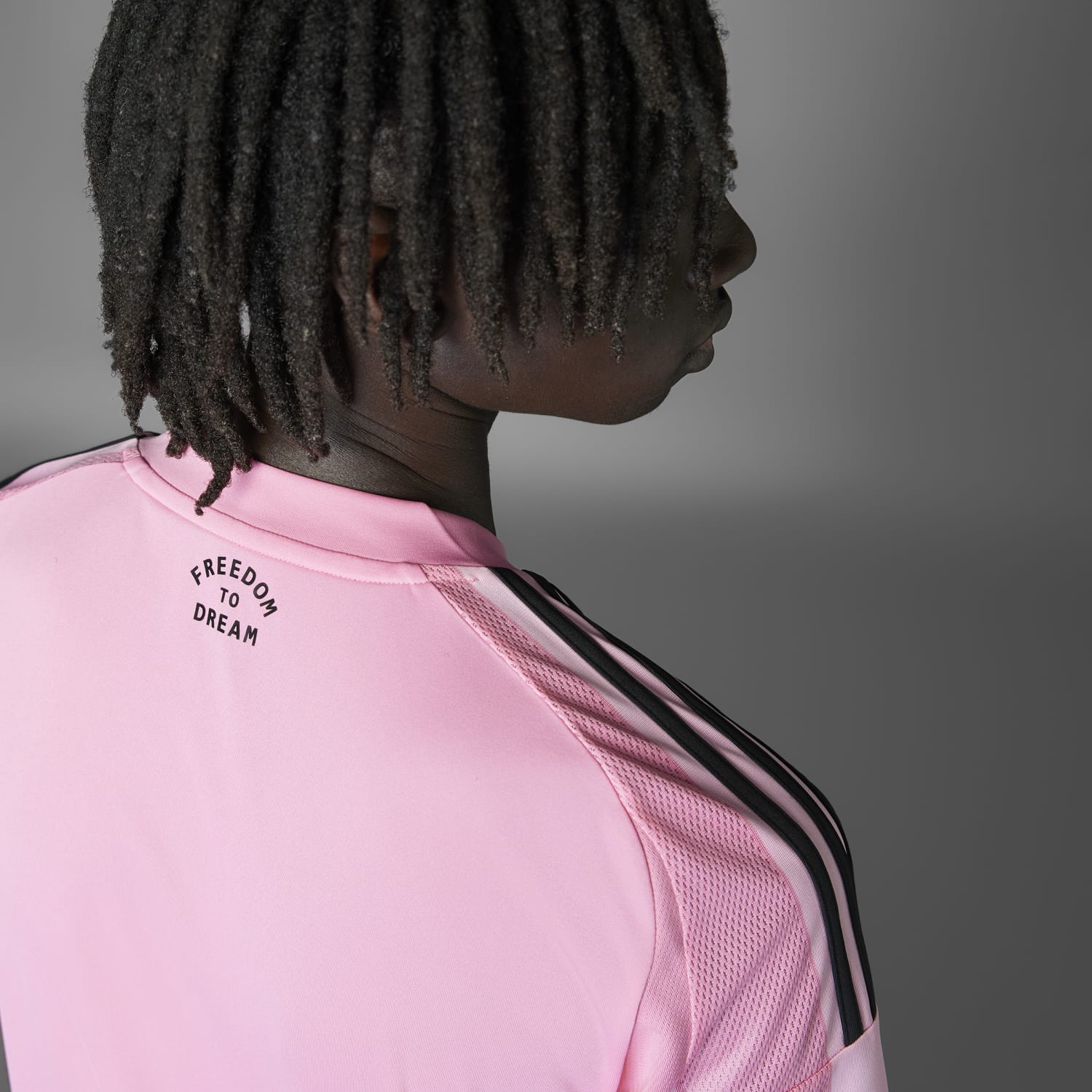 Model wearing the Inter Miami replica jersey at a soccer stadium