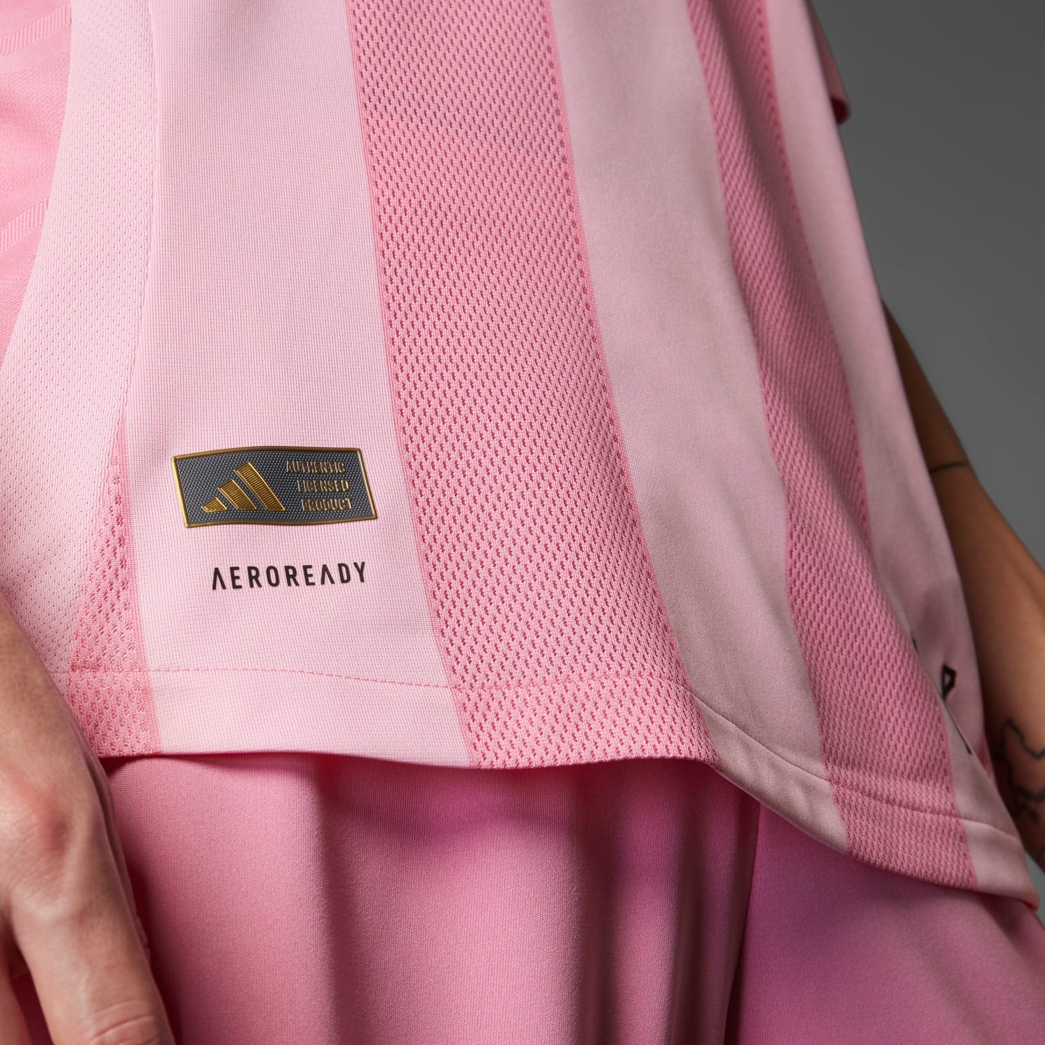 Side angle of the Inter Miami jersey highlighting the adidas three-stripe logo and AEROREADY technology.