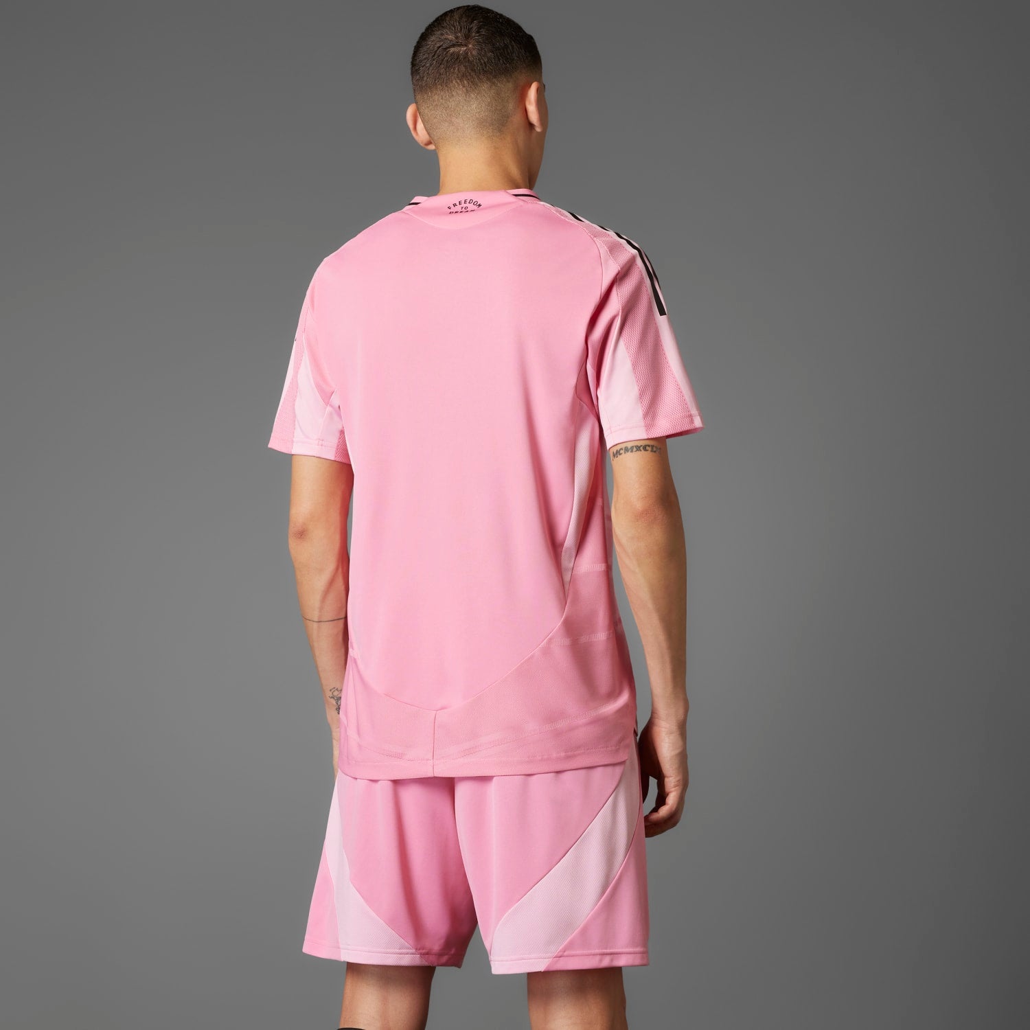 Side angle of the Inter Miami jersey highlighting the adidas three-stripe logo and AEROREADY technology.