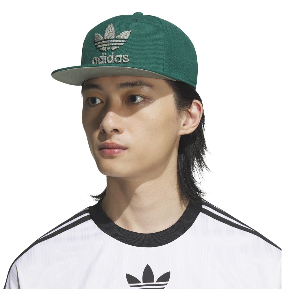 Side angle of the Adidas Trefoil Snapback Cap worn casually, emphasizing its adjustable fit and stylish design.