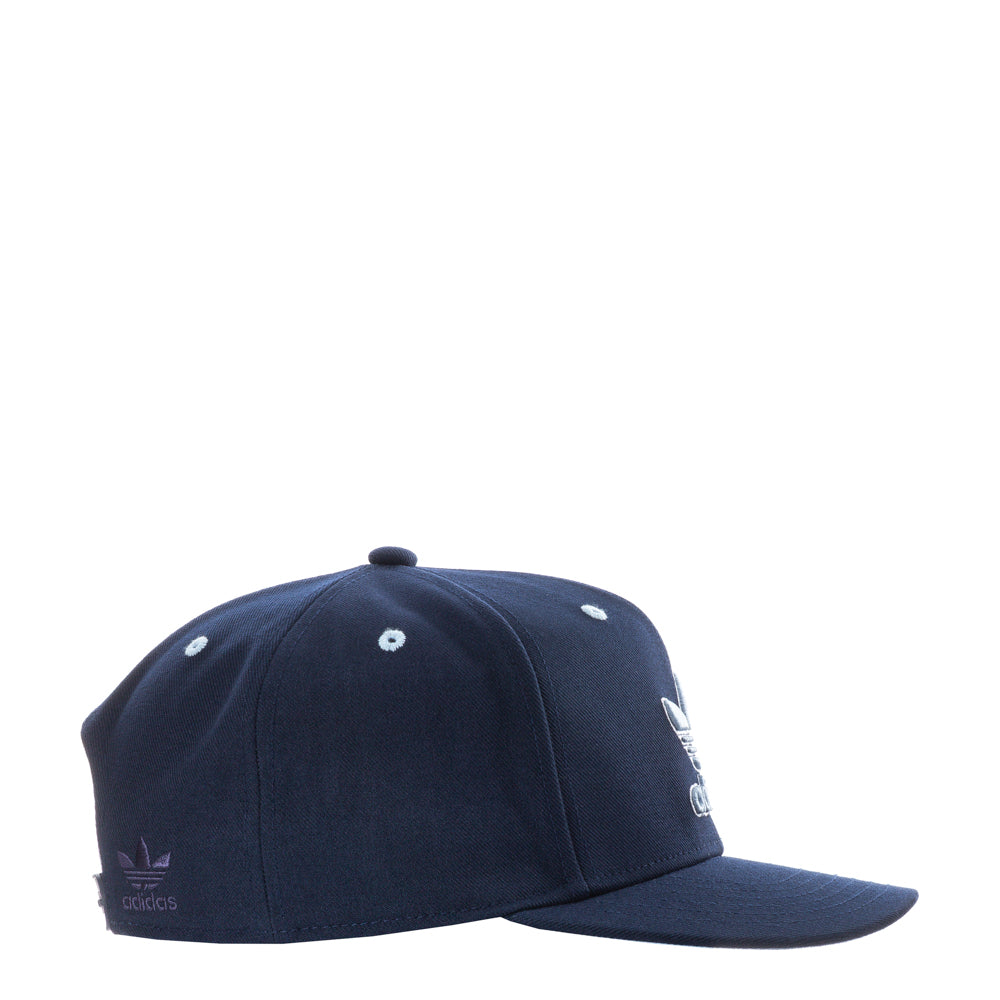 Adidas structured cap worn casually during a sunny day, displaying its stylish silhouette.