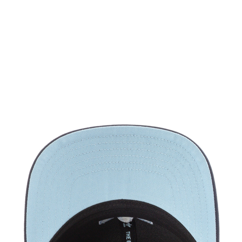 Adidas structured cap worn casually during a sunny day, displaying its stylish silhouette.