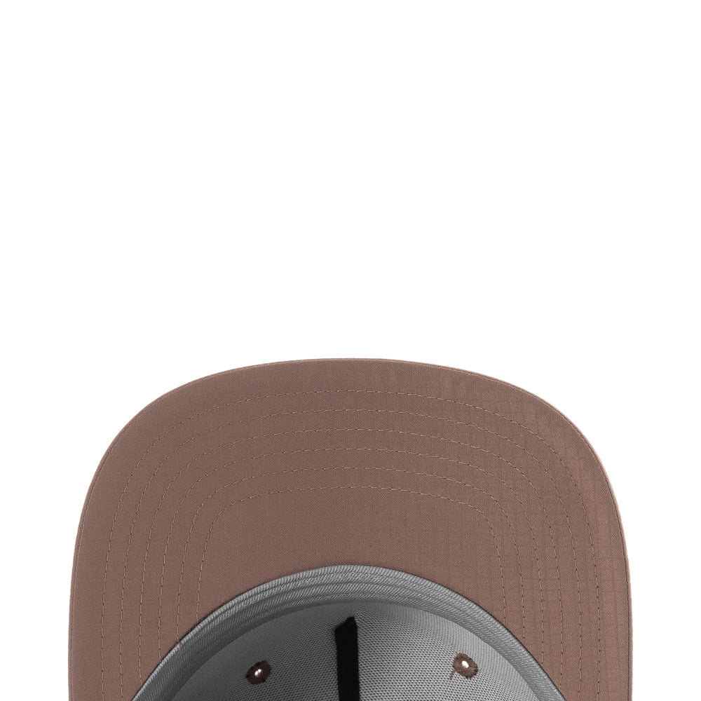 Side profile of the cap in action on a skateboarder—breathable holes visible under bright sunlight