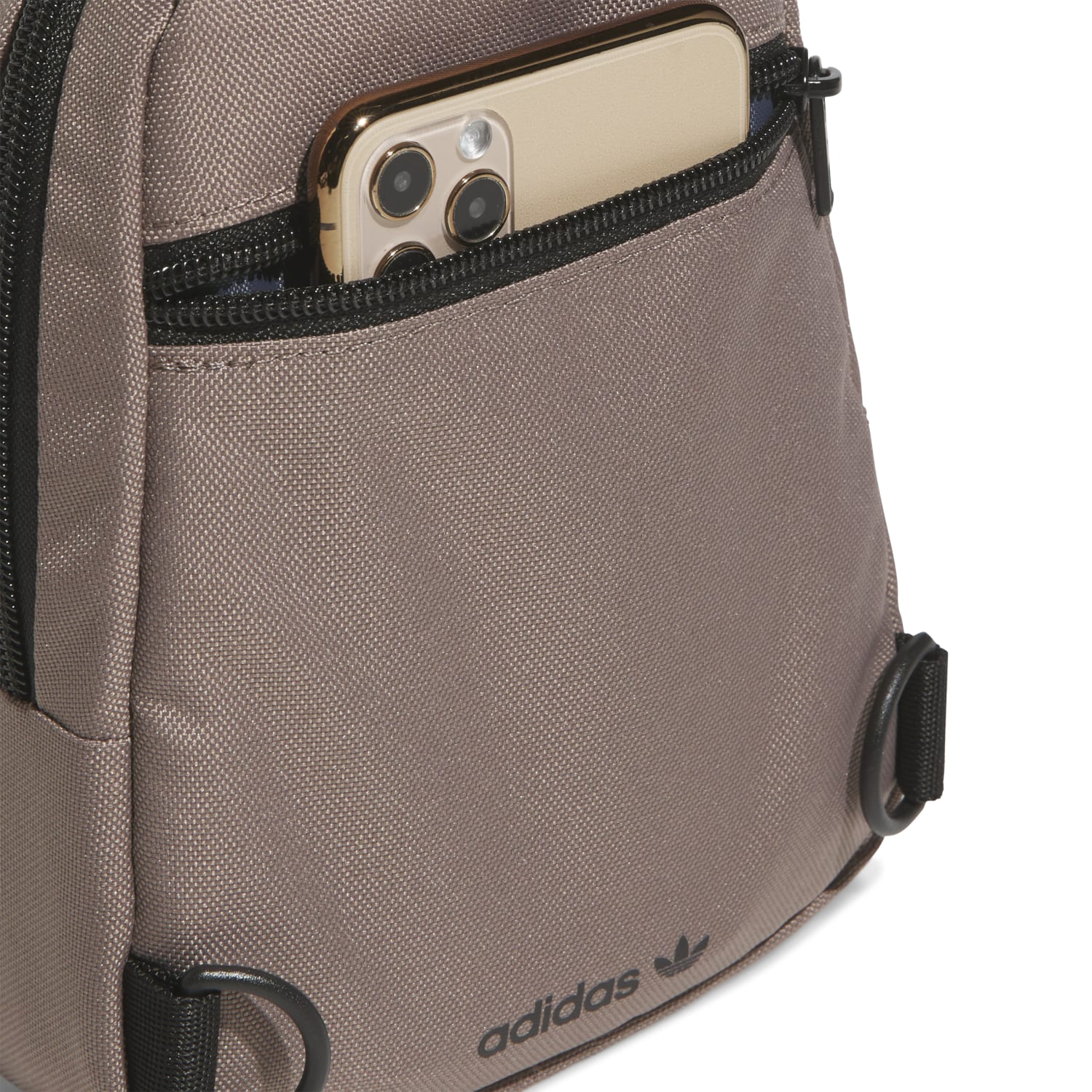 Model carrying the compact sling purse while traveling through an urban environment