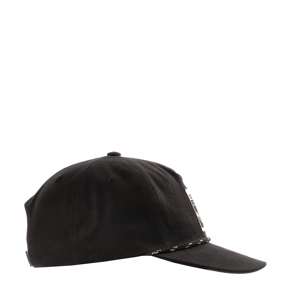 Side profile displaying low-crown fit and flat brim on a city street backdrop
