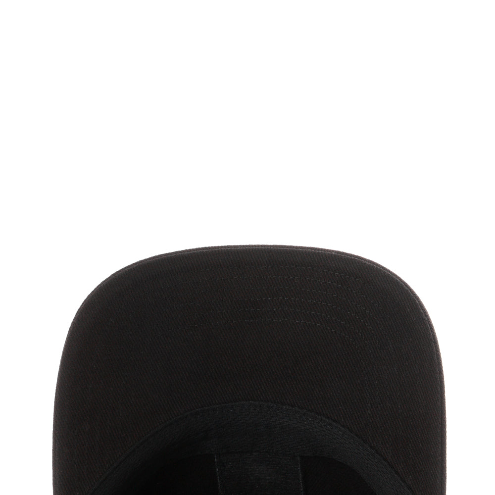 Side profile displaying low-crown fit and flat brim on a city street backdrop
