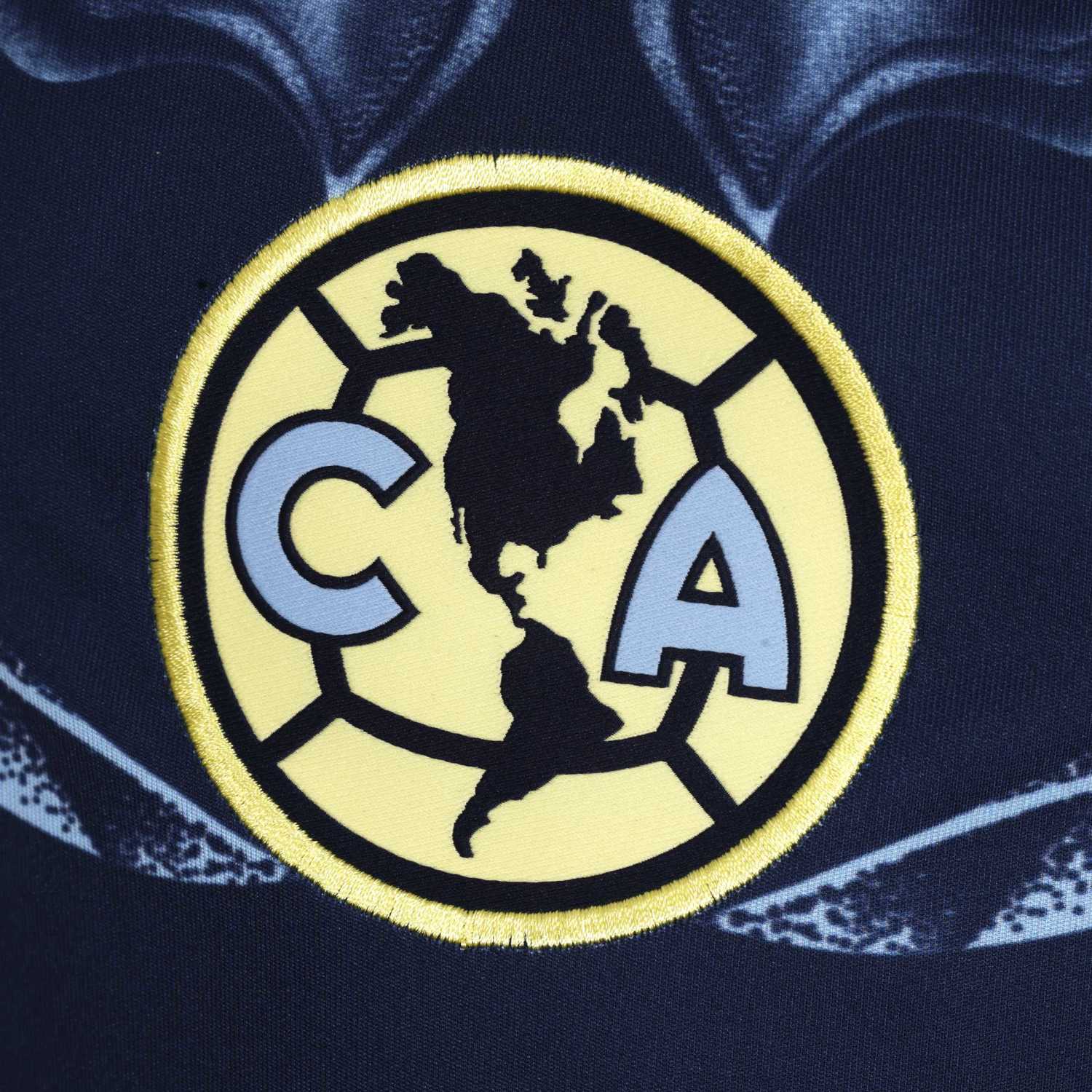 Front view of youth soccer player in Club America away jersey on the field
