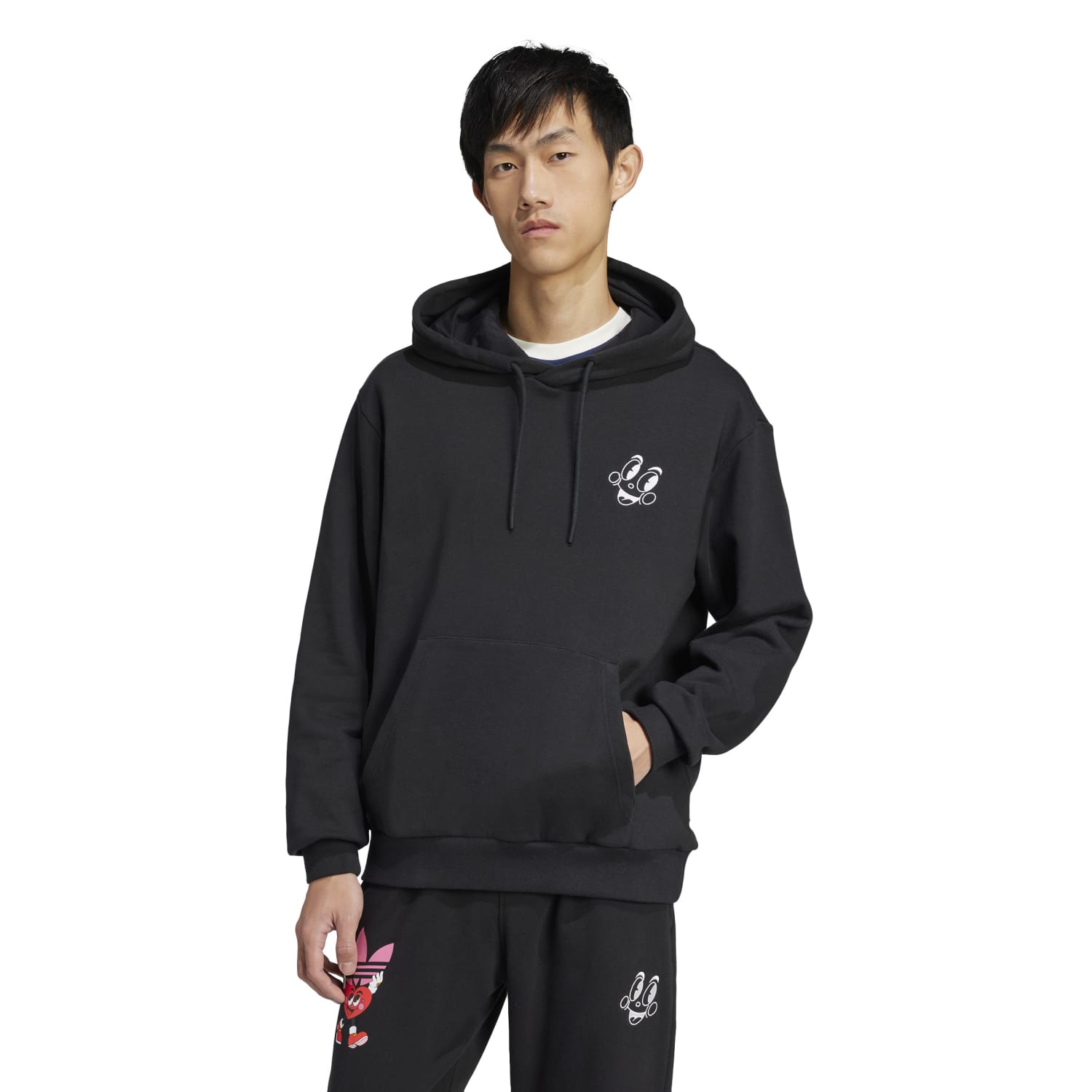 Side angle of Nelson Classic adidas hoodie styled with jeans outdoors
