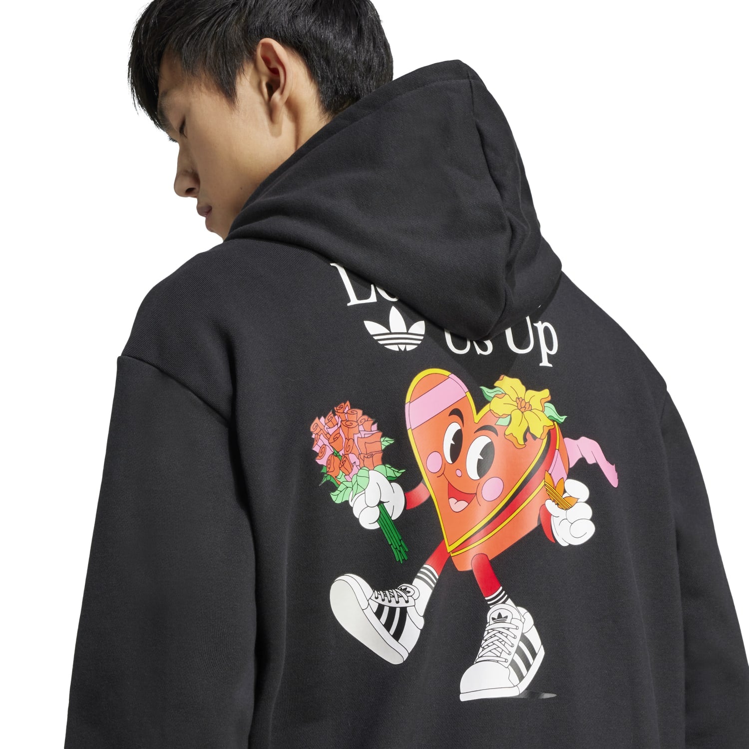 Side angle of Nelson Classic adidas hoodie styled with jeans outdoors