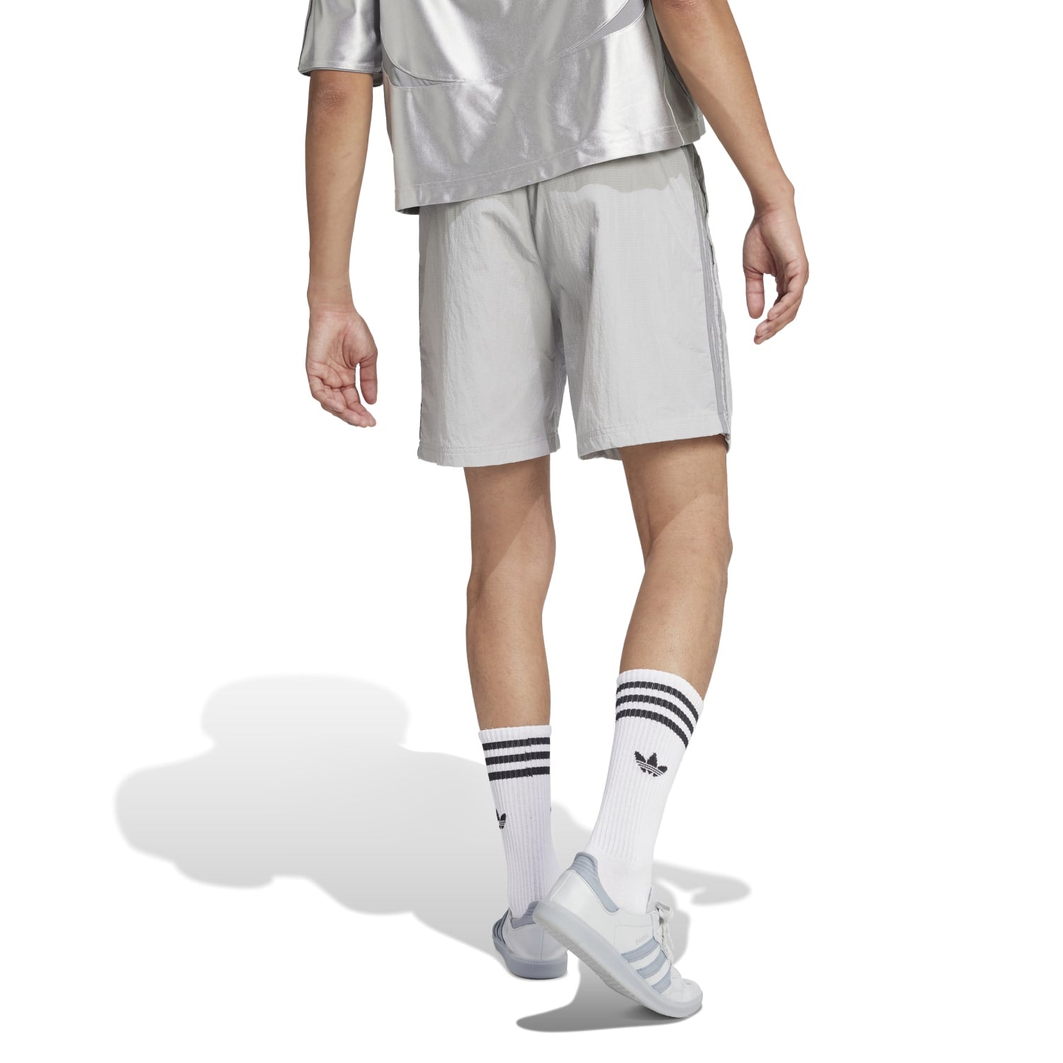 Model wearing Retro Adicolor 2000s Mens Casual Shorts at the beach.