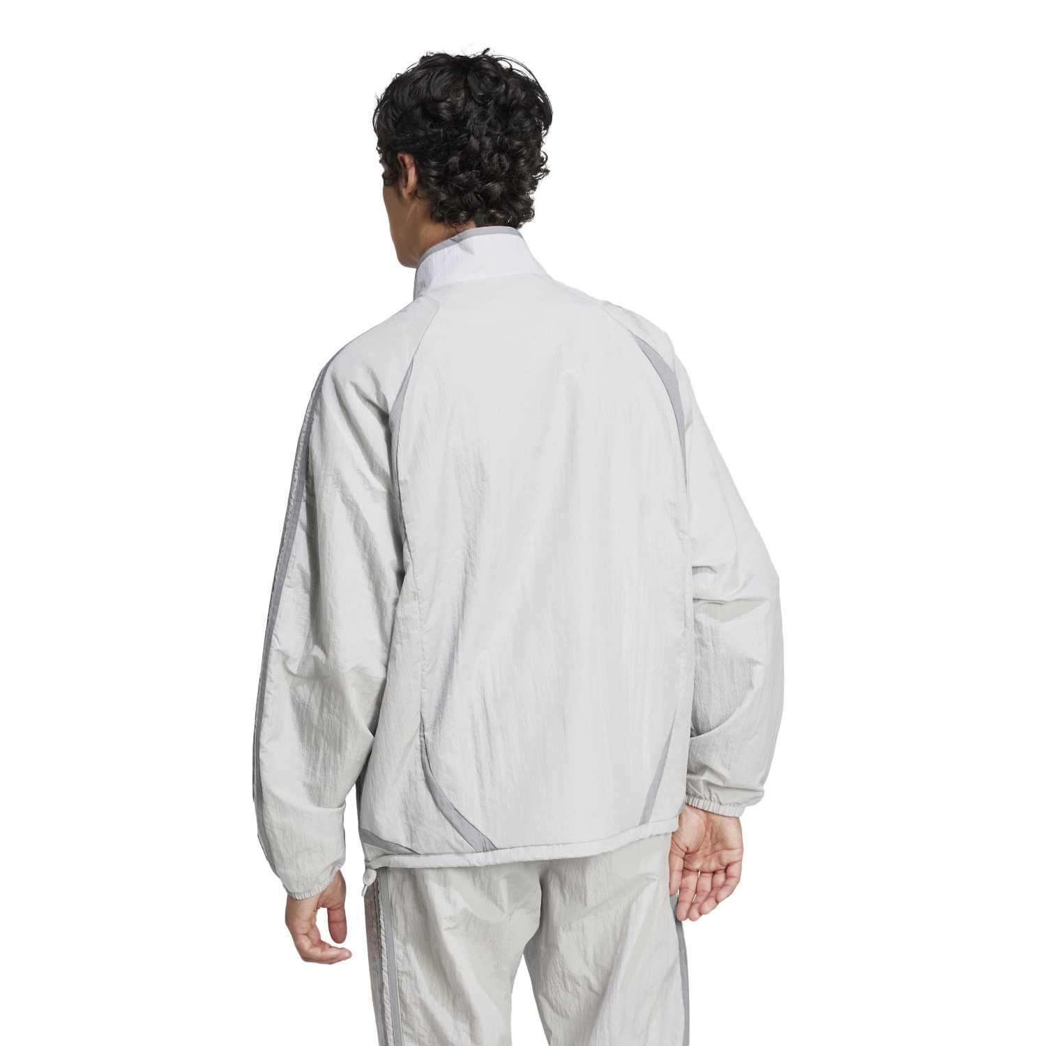 Man wearing the Adicolor Vintage Woven Track Jacket during a casual outing, demonstrating its style and versatility.