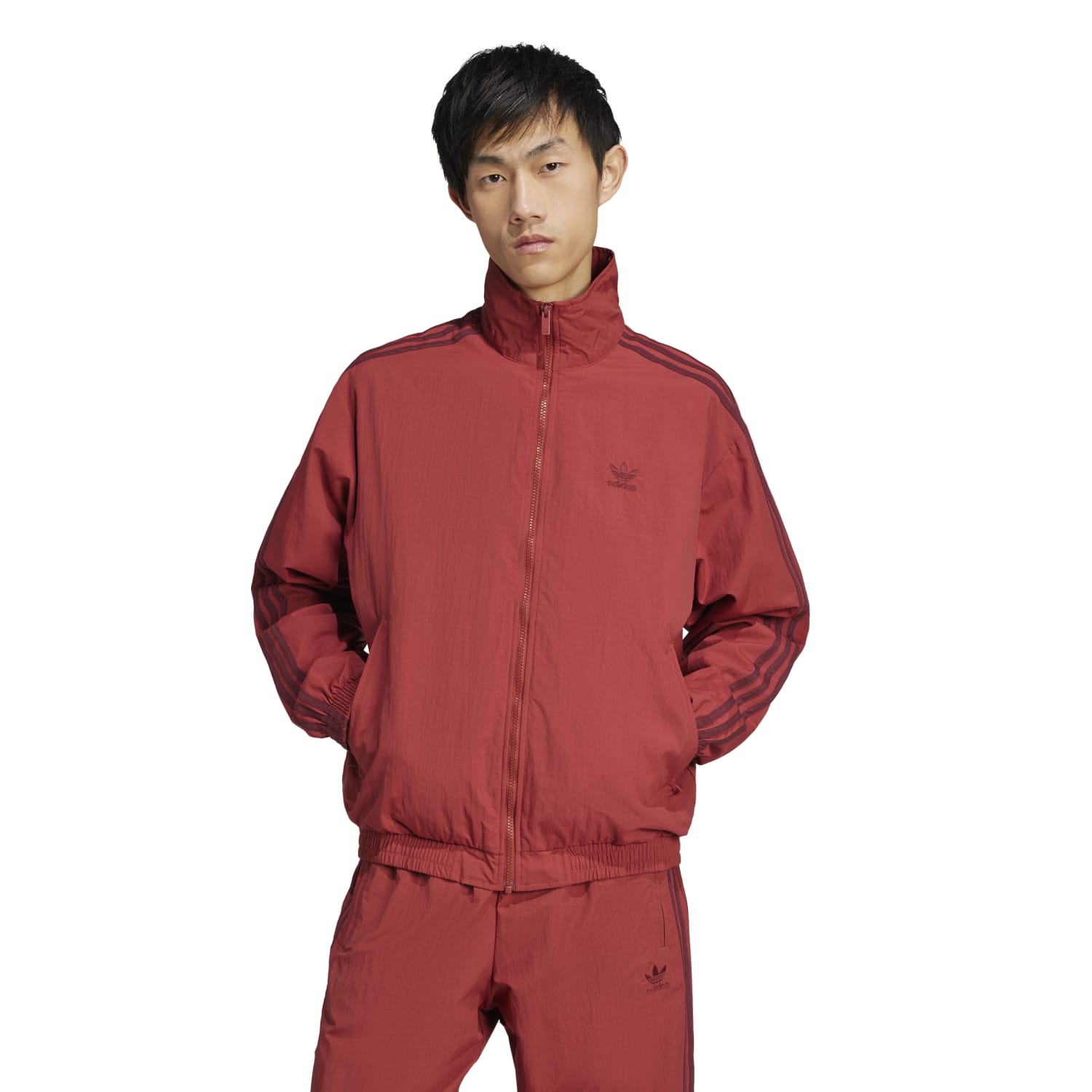 Side view of the mens track top featuring ribbed cuffs and a collared neck.