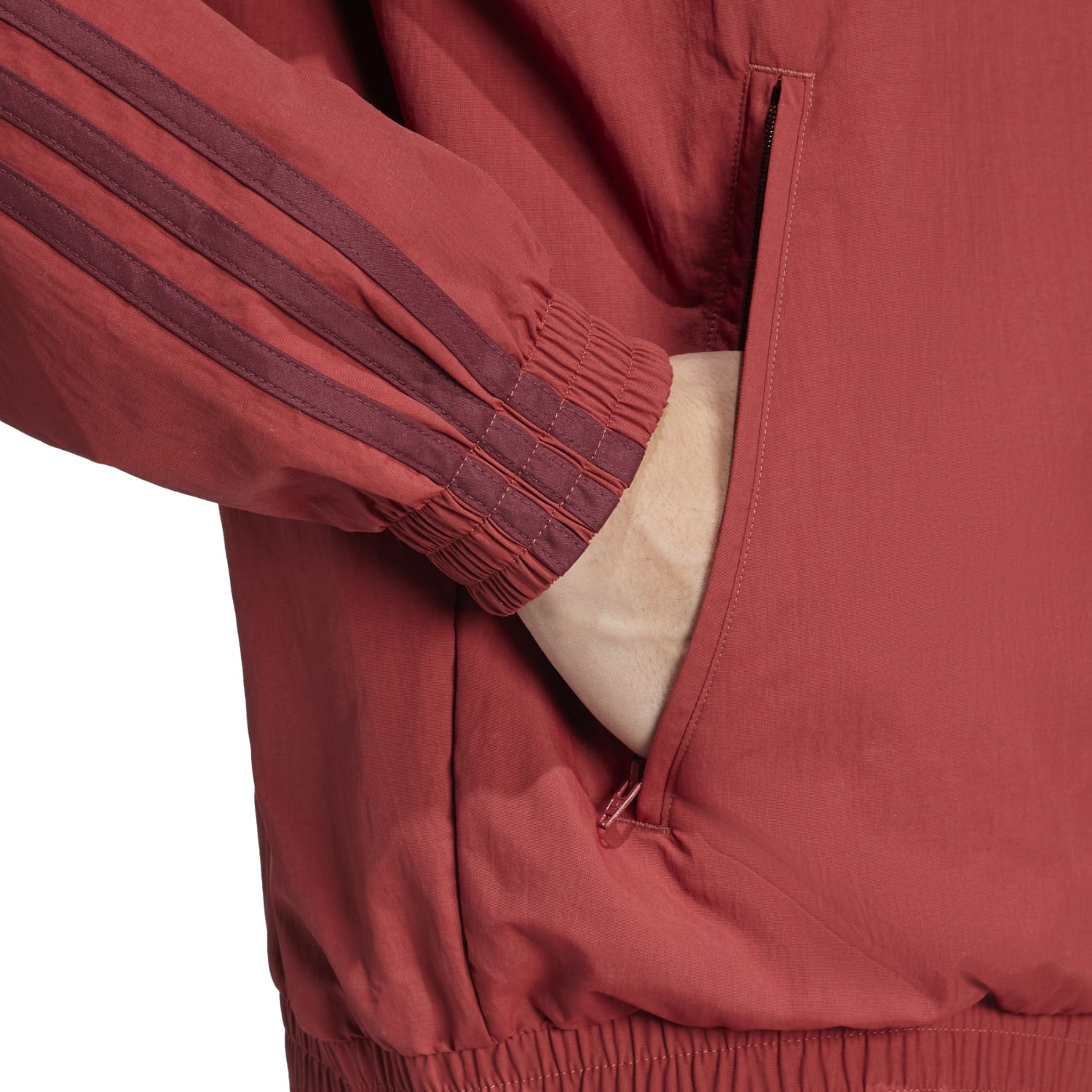 Side view of the mens track top featuring ribbed cuffs and a collared neck.