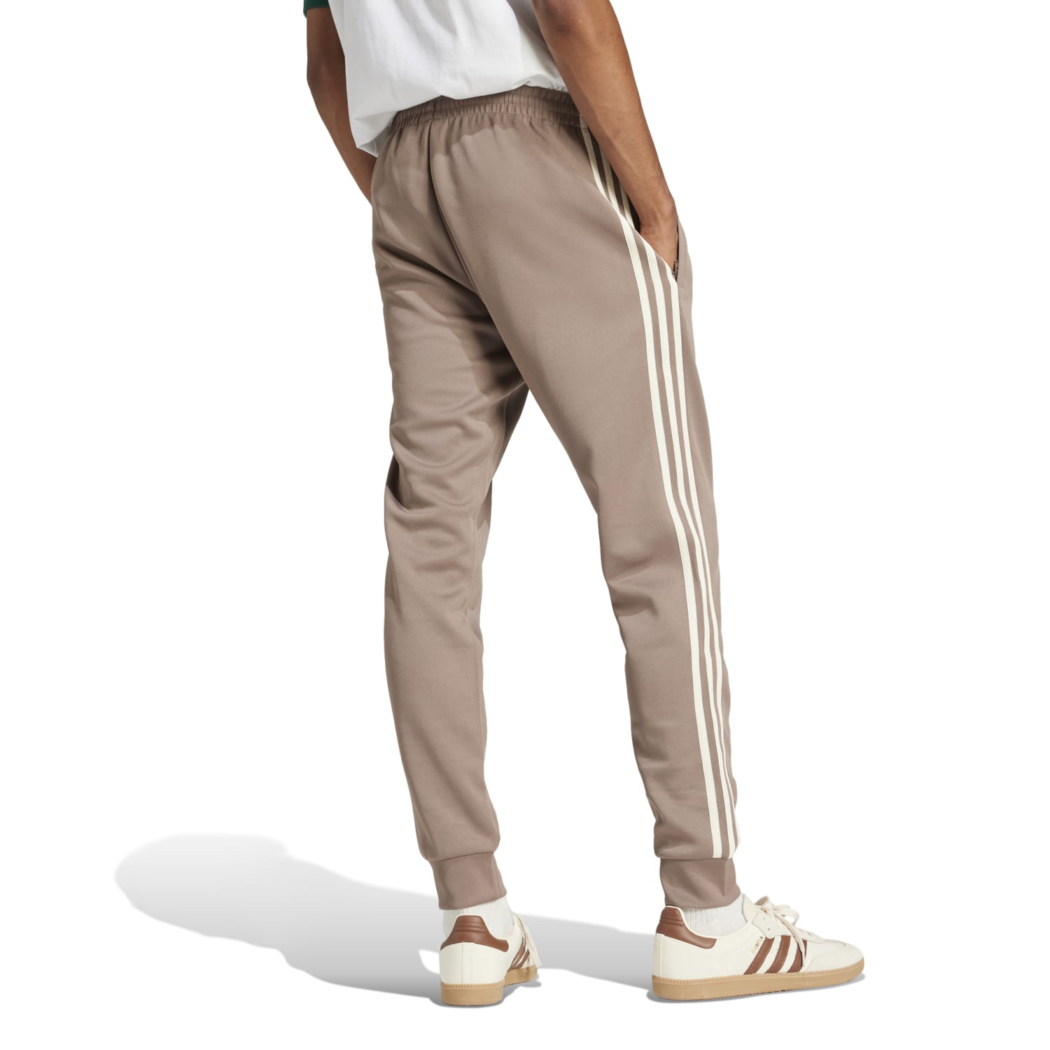 Side view of the Adidas Superstar Slim Fit Track Pants highlighting the tapered cuffs and iconic 3-Stripes.
