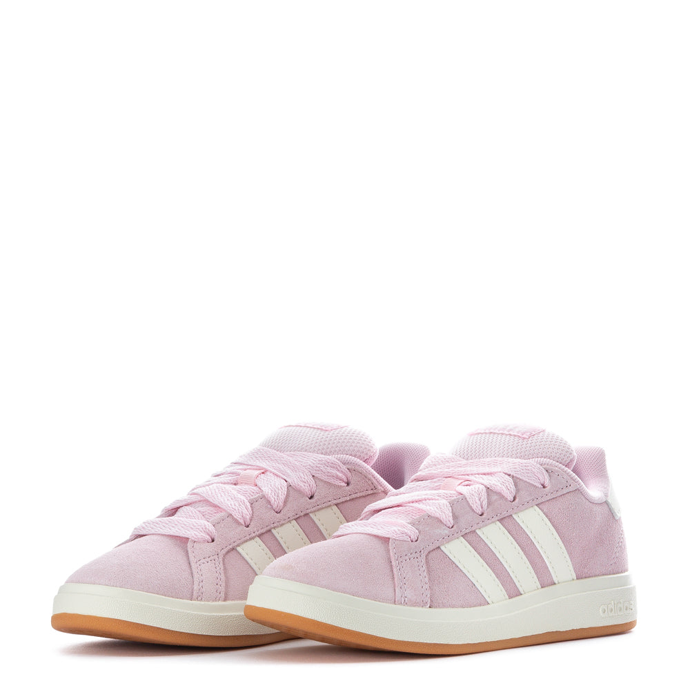 Side view of Adidas kids shoes showing durable sole and classic white leather finish