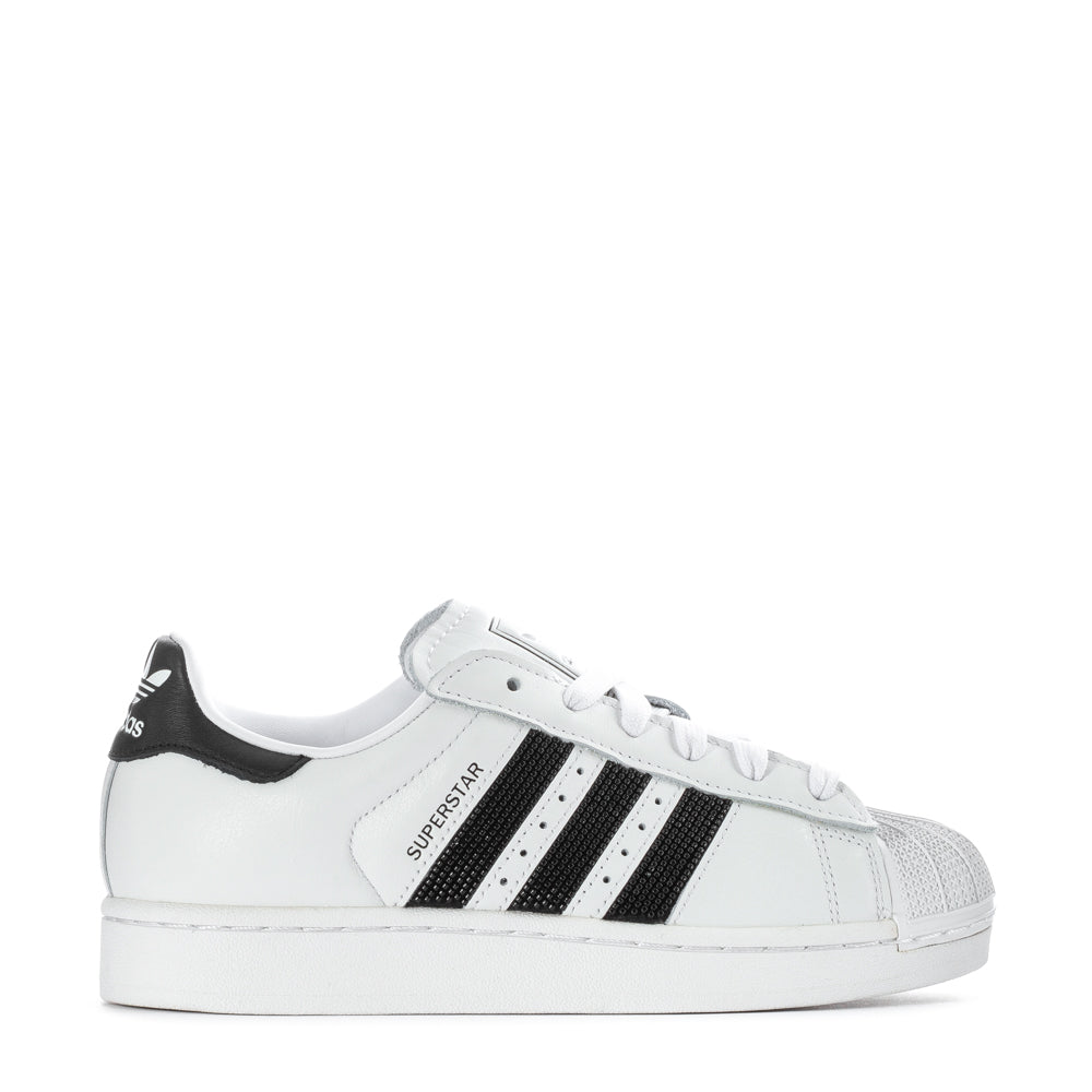Adidas Superstar II women's sneakers featuring a classic rubber shell toe and stylish leather design from the side.