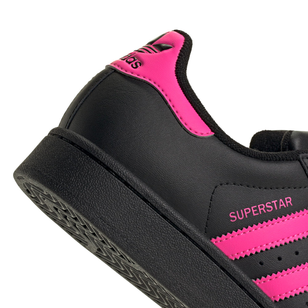 Side view of Adidas Superstar Youth Sneakers in monochrome design, perfect for stylish youth.
