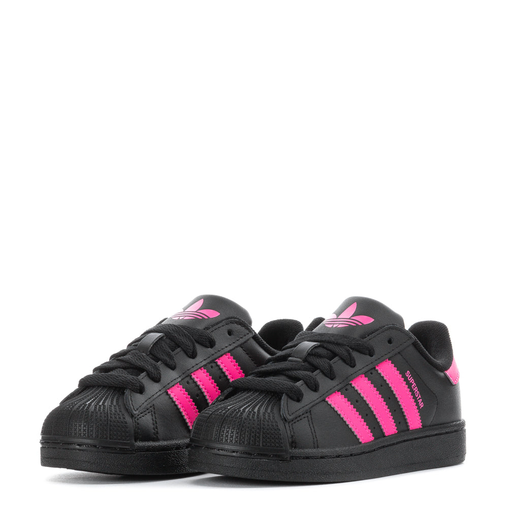 Adidas Superstar II kids sneakers worn by a child, showcasing their stylish design during playtime.